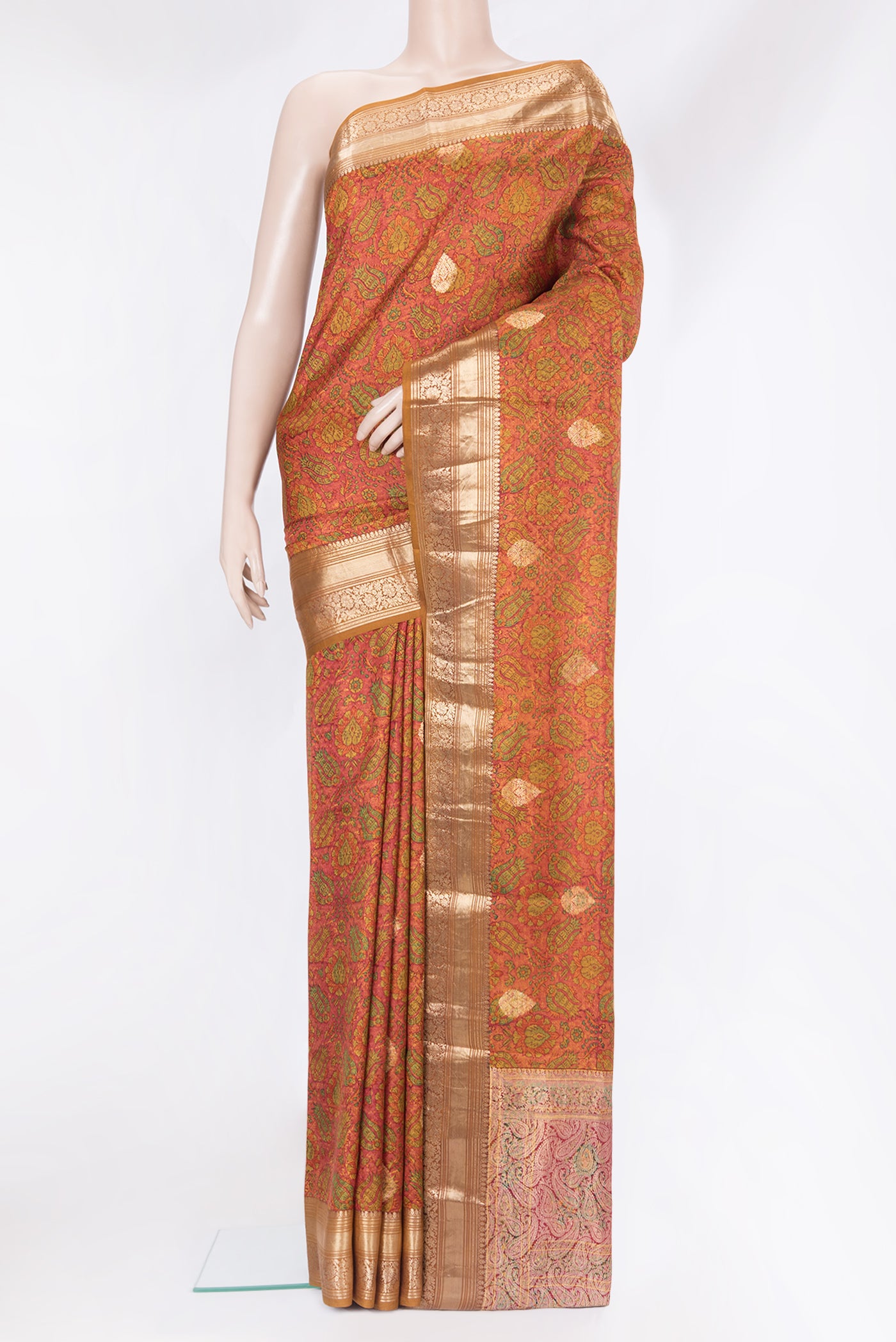 Orange Kanchipuram Silk Saree with Printed design on the body and Zari Border.  displayed on a mannequin