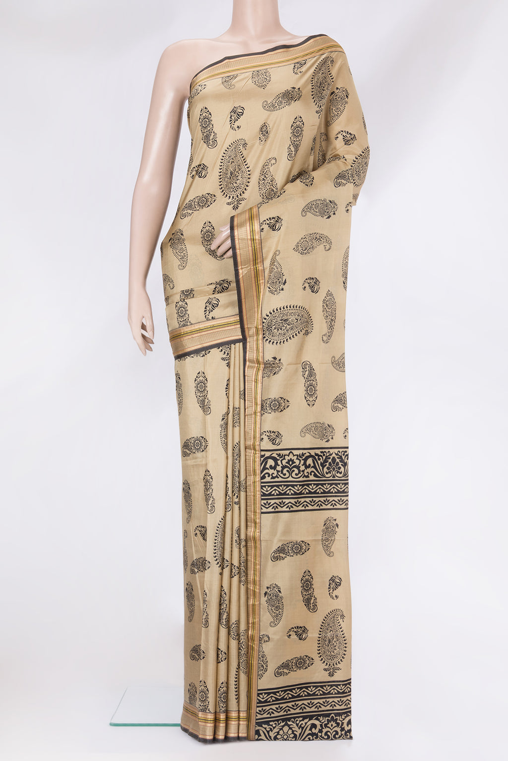 Beige Printed Silk Saree with Printed design on the body and Thread Border.  displayed on a mannequin