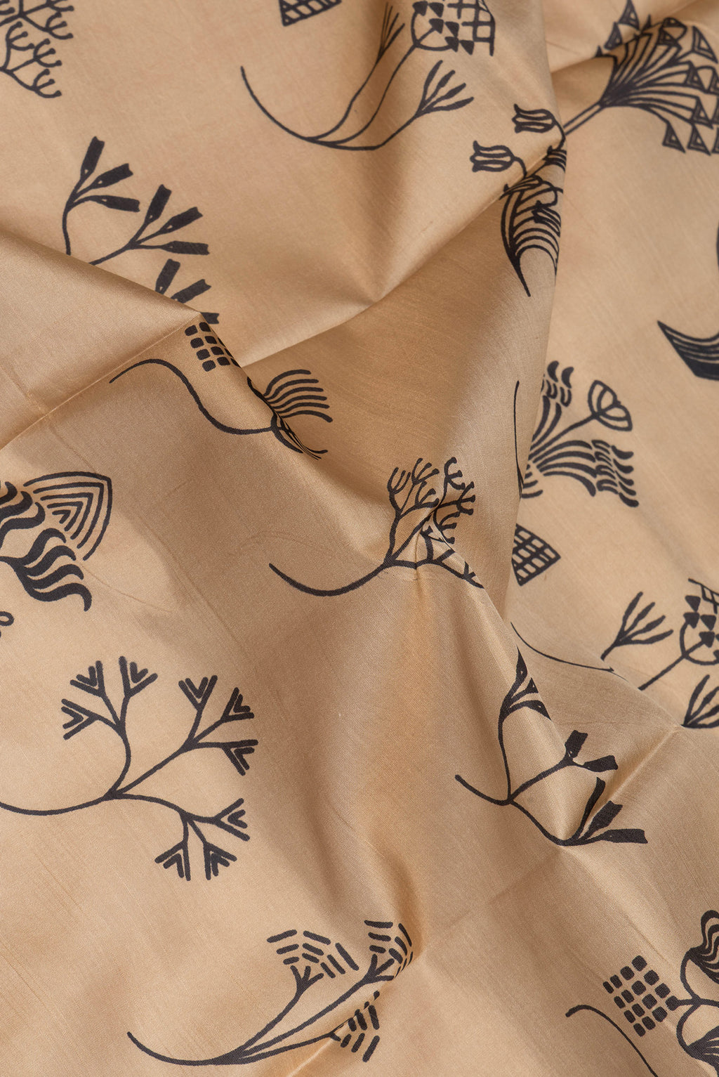 Close up of Beige Printed Silk Saree with Printed design on the body and Thread Border.  displaying folds