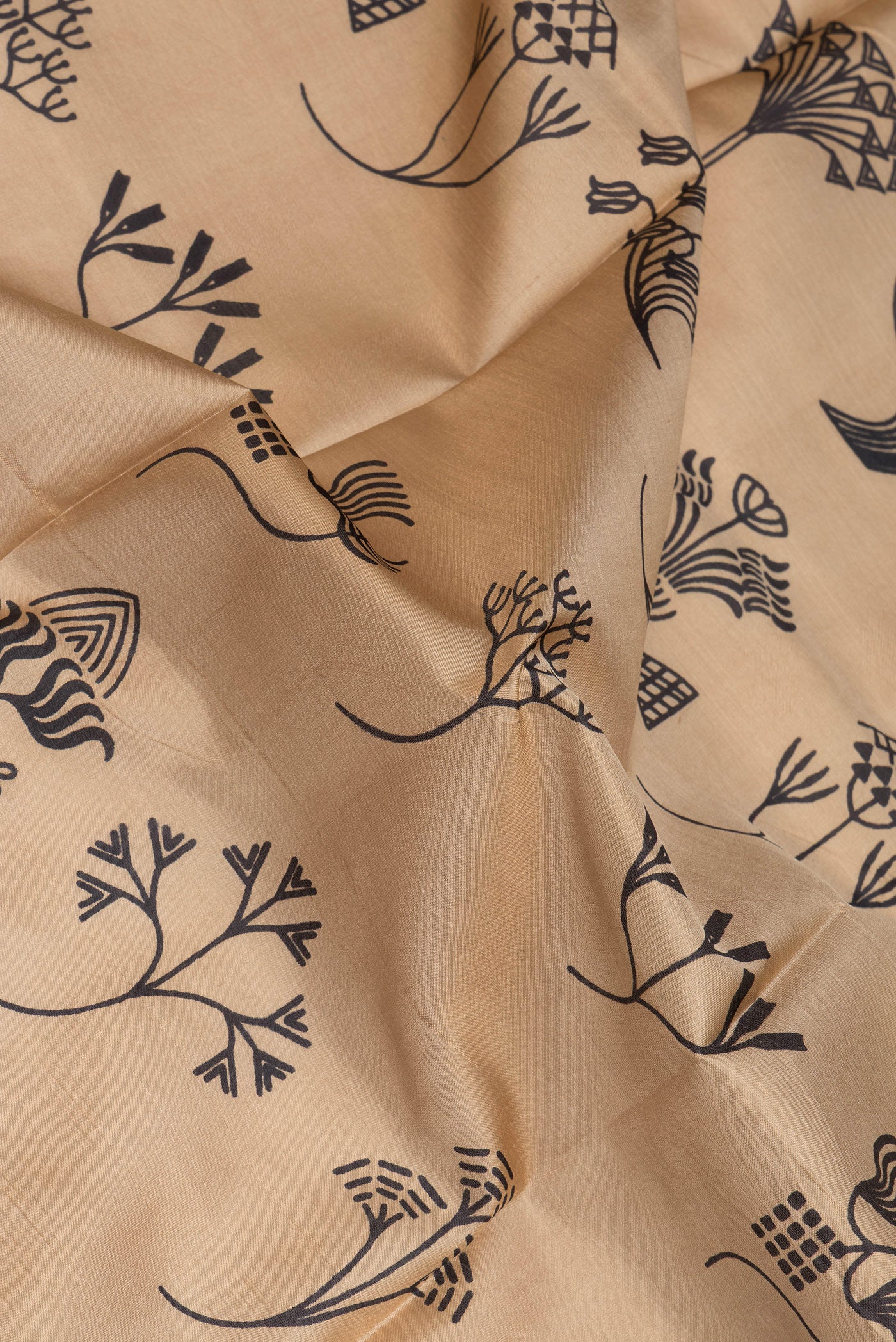 Close up of Beige Printed Silk Saree with Printed design on the body and Thread Border.  displaying folds