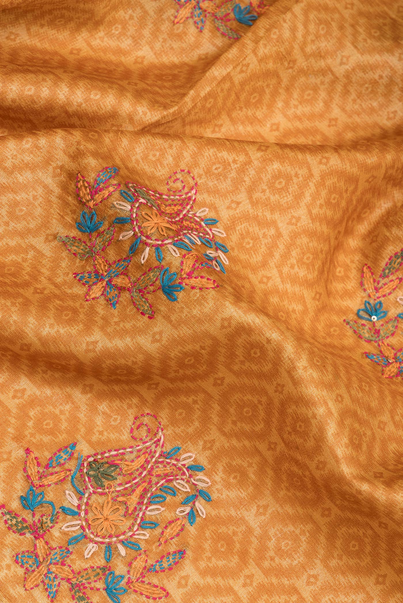 Close up of Mustard Tussar Silk Saree with Embroidery on the body and Zari Border.  displaying folds