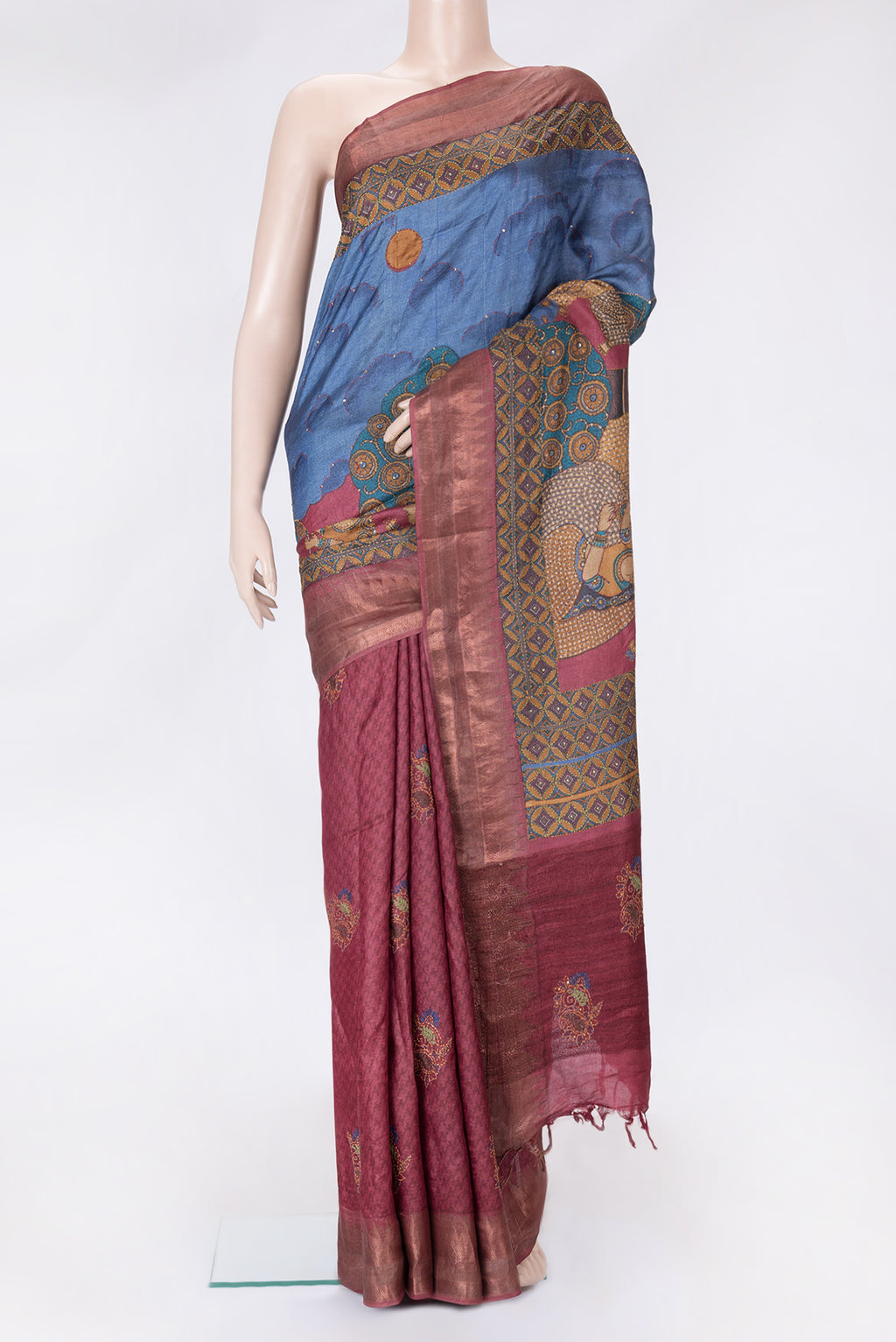 Peacock Blue Dual Tone Tussar Silk Saree with Printed design on the body and Embroidery Border.  displayed on a mannequin