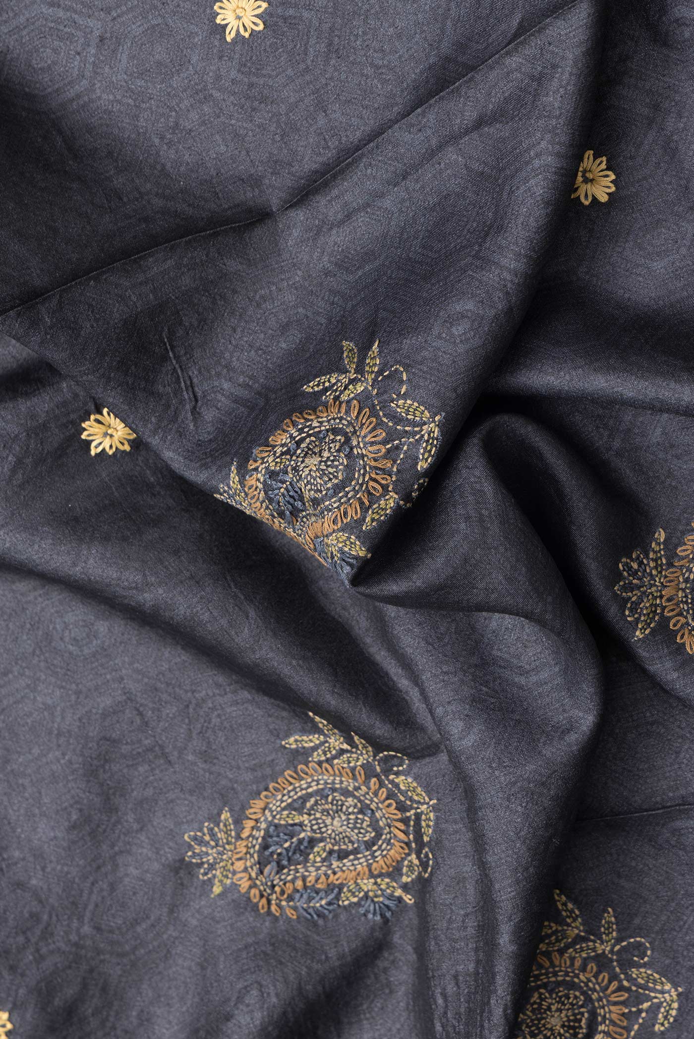 Close up of Black Dual Tone Tussar Silk Saree with Embroidery on the body and Zari Border.  displaying folds