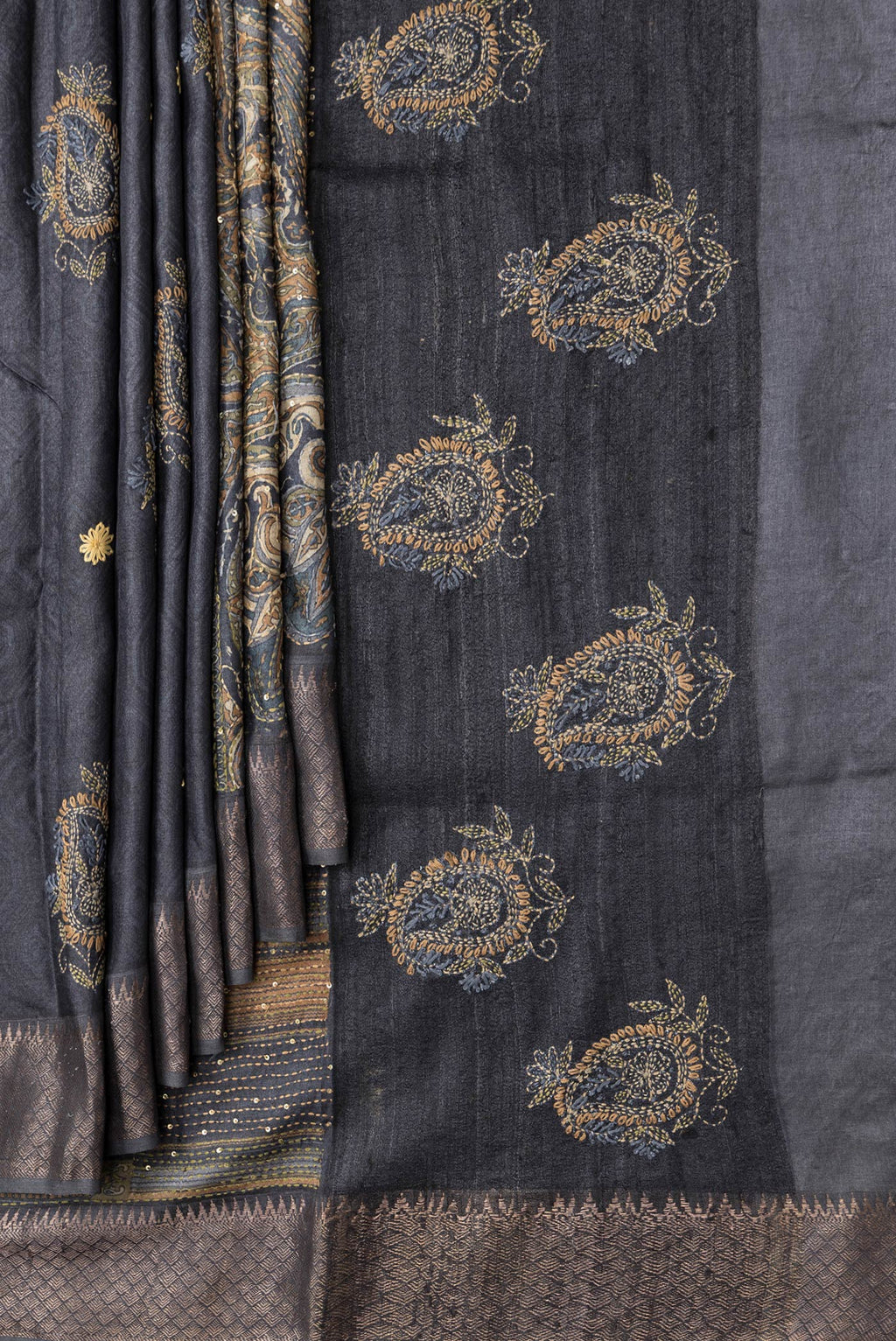 Pleats and pallu of Black Dual Tone Tussar Silk Saree with Embroidery on the body and Zari Border. 
