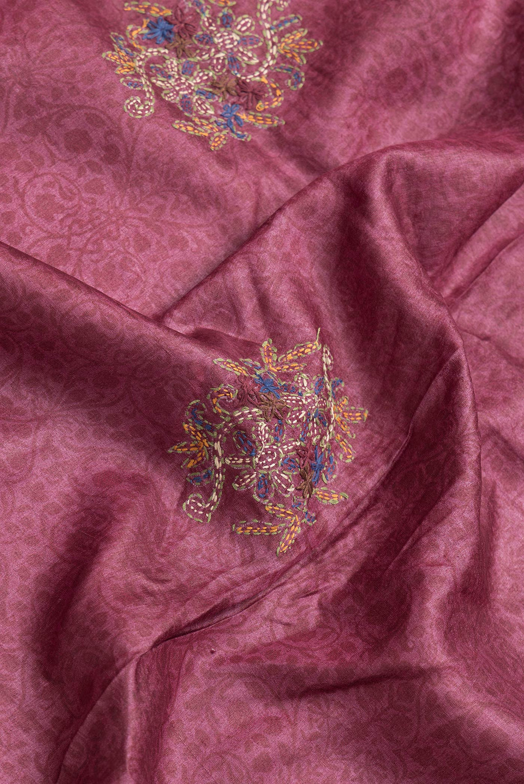 Close up of Magenta Dual Tone Tussar Silk Saree with Embroidery on the body and Zari Border.  displaying folds