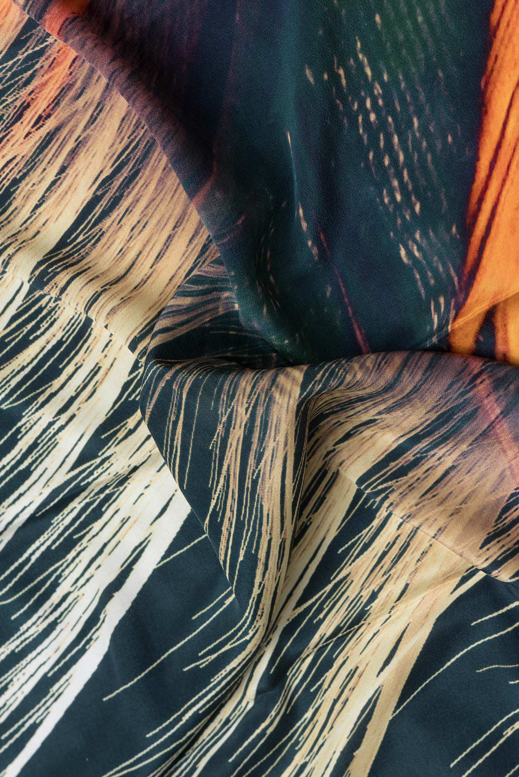 Close up of Green Dual Tone Mysore Crepe Saree with Printed design on the body and Plain Border.  displaying folds