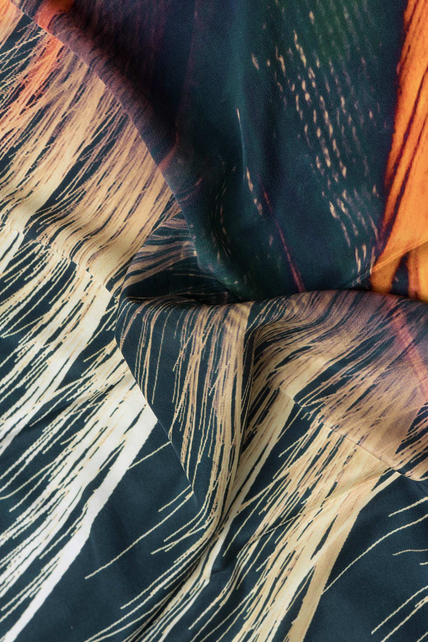 Close up of Green Dual Tone Mysore Crepe Saree with Printed design on the body and Plain Border.  displaying folds