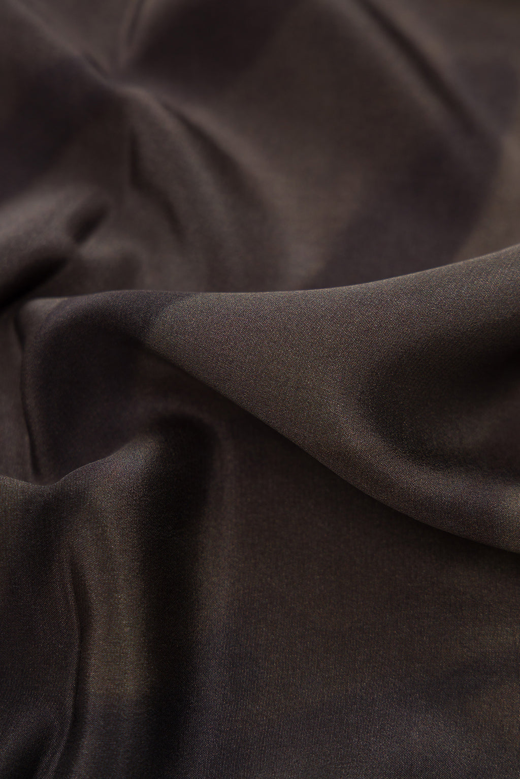 Close up of Black Dual Tone Mysore Crepe Saree with Printed design on the body and Plain Border.  displaying folds