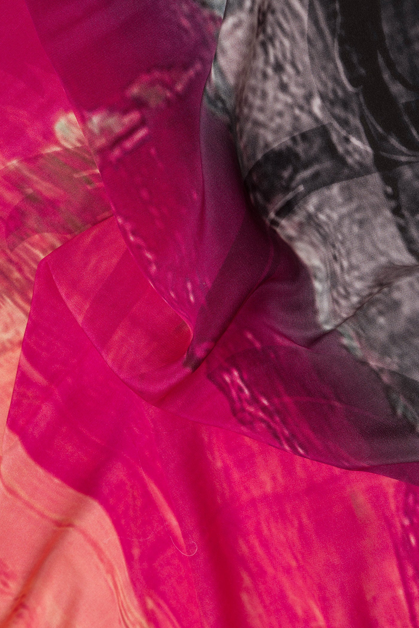Close up of Grey Dual Tone Mysore Crepe Saree with Printed design on the body and Plain Border.  displaying folds