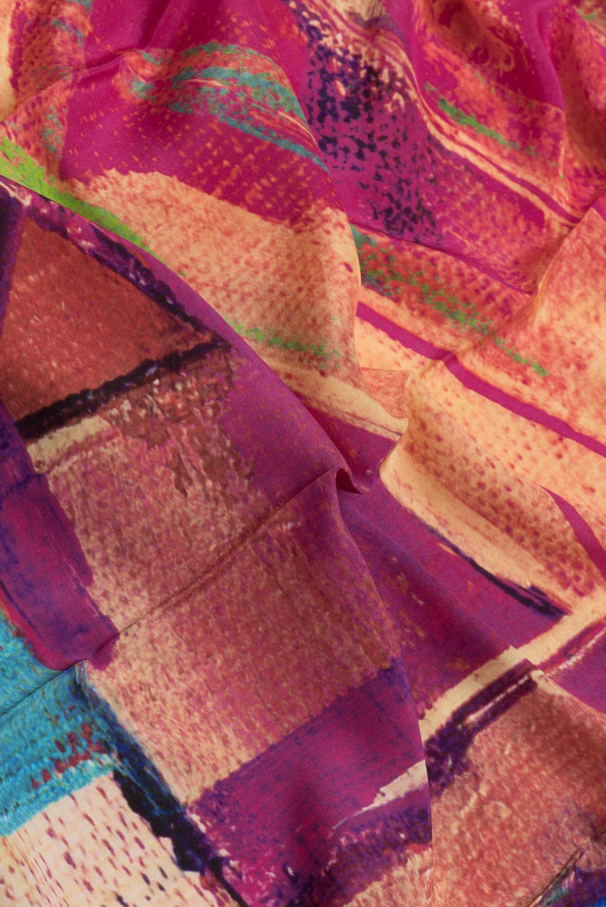 Close up of Pink Dual Tone Mysore Crepe Saree with Printed design on the body and Without Border.  displaying folds