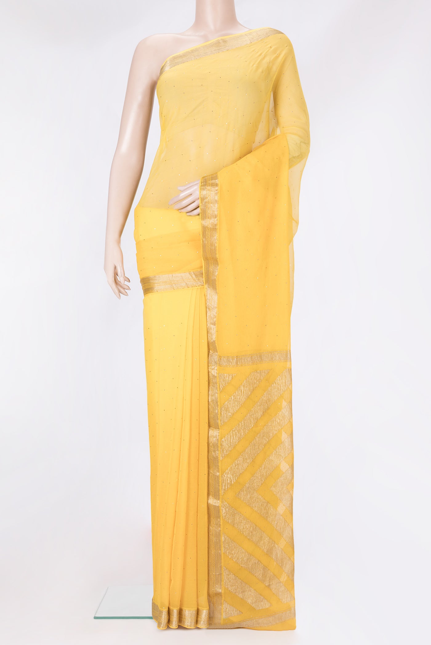 Yellow Chiffon Saree with Embroidery on the body and Zari Border.  displayed on a mannequin