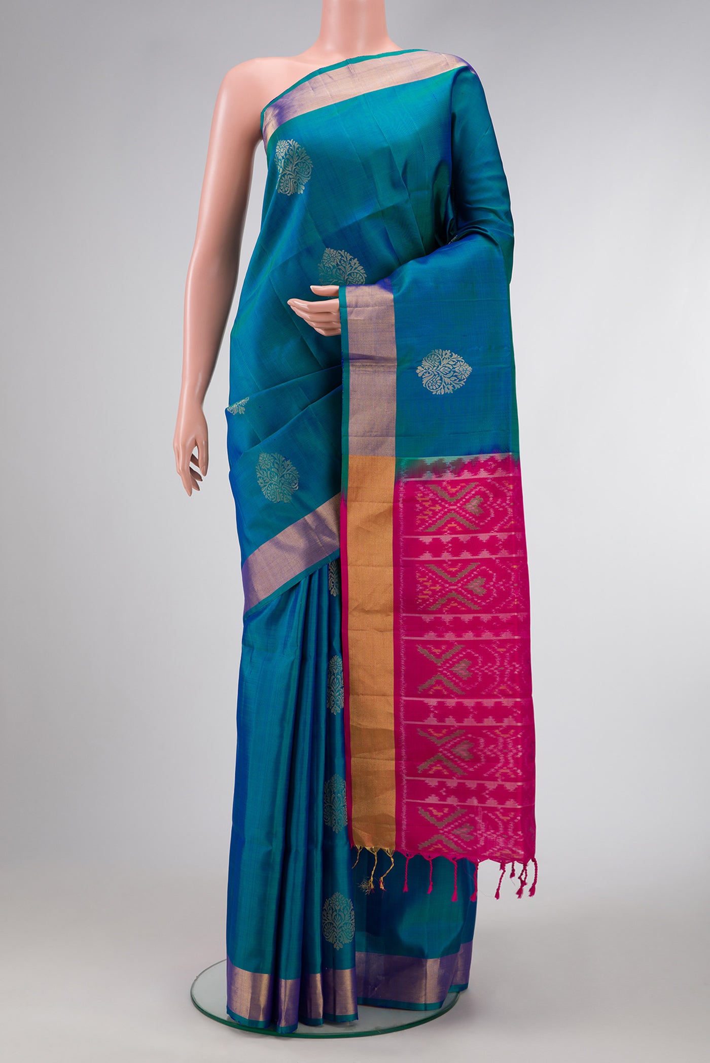 Peacock Blue Dual Tone Soft Silk Saree with Zari Butta on the body and Zari Border.  displayed on a mannequin