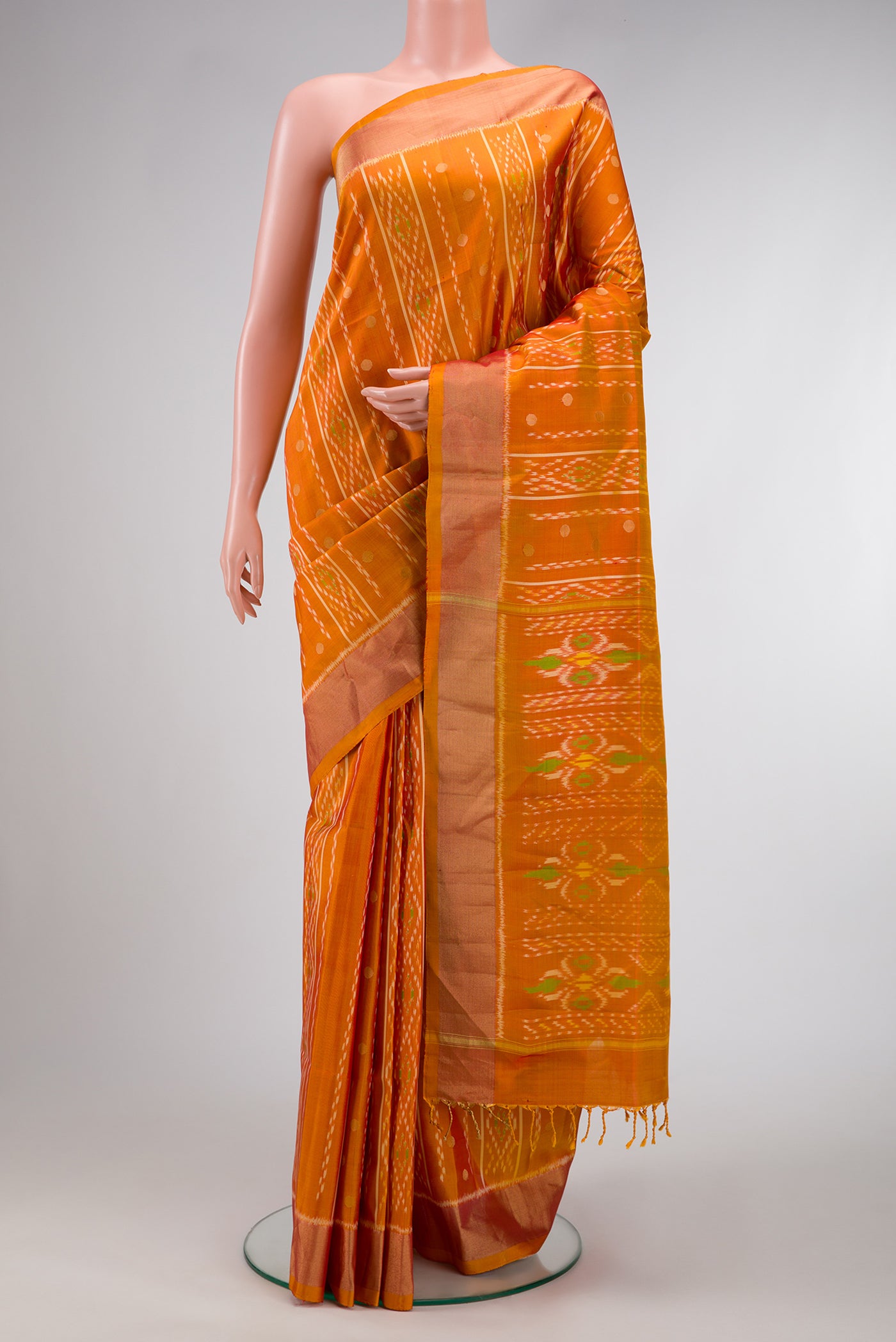 Mustard Dual Tone Soft Silk Saree with Ikat Print on the body and Zari Border.  displayed on a mannequin