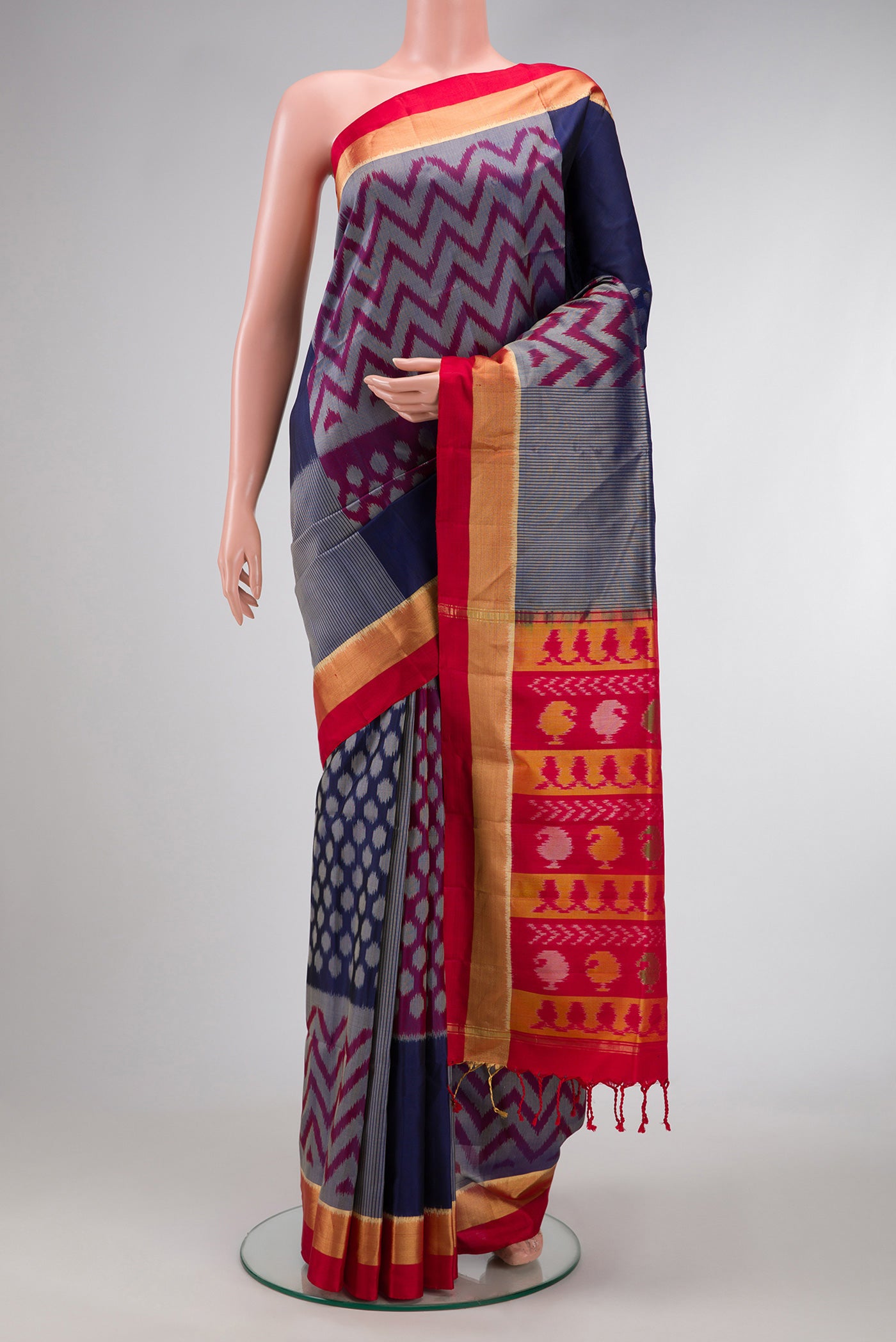 Navy Blue Dual Tone Soft Silk Saree with Ikat Print on the body and Zari Border.  displayed on a mannequin