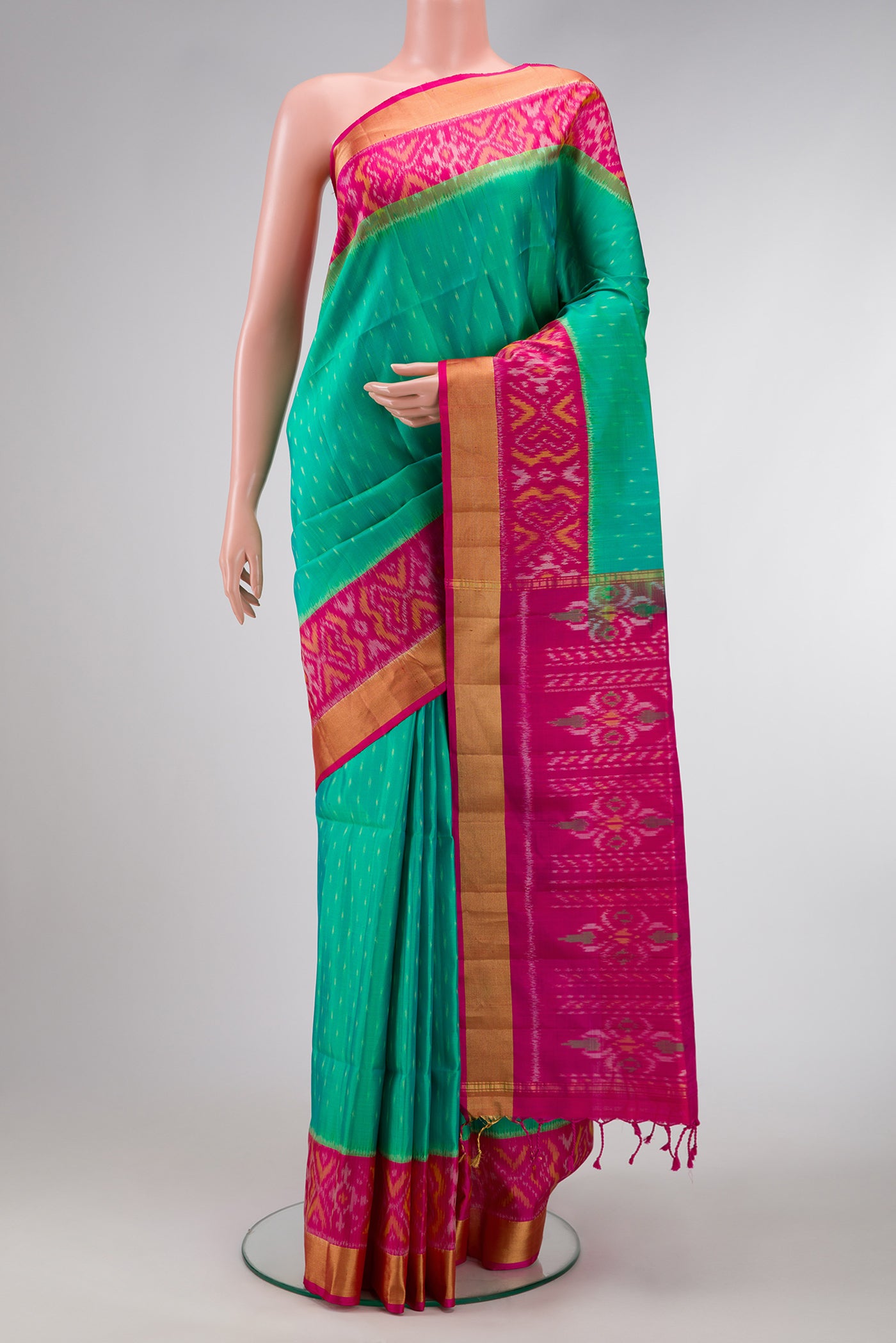 Green Dual Tone Soft Silk Saree with Ikat Print on the body and Ikat Border.  displayed on a mannequin