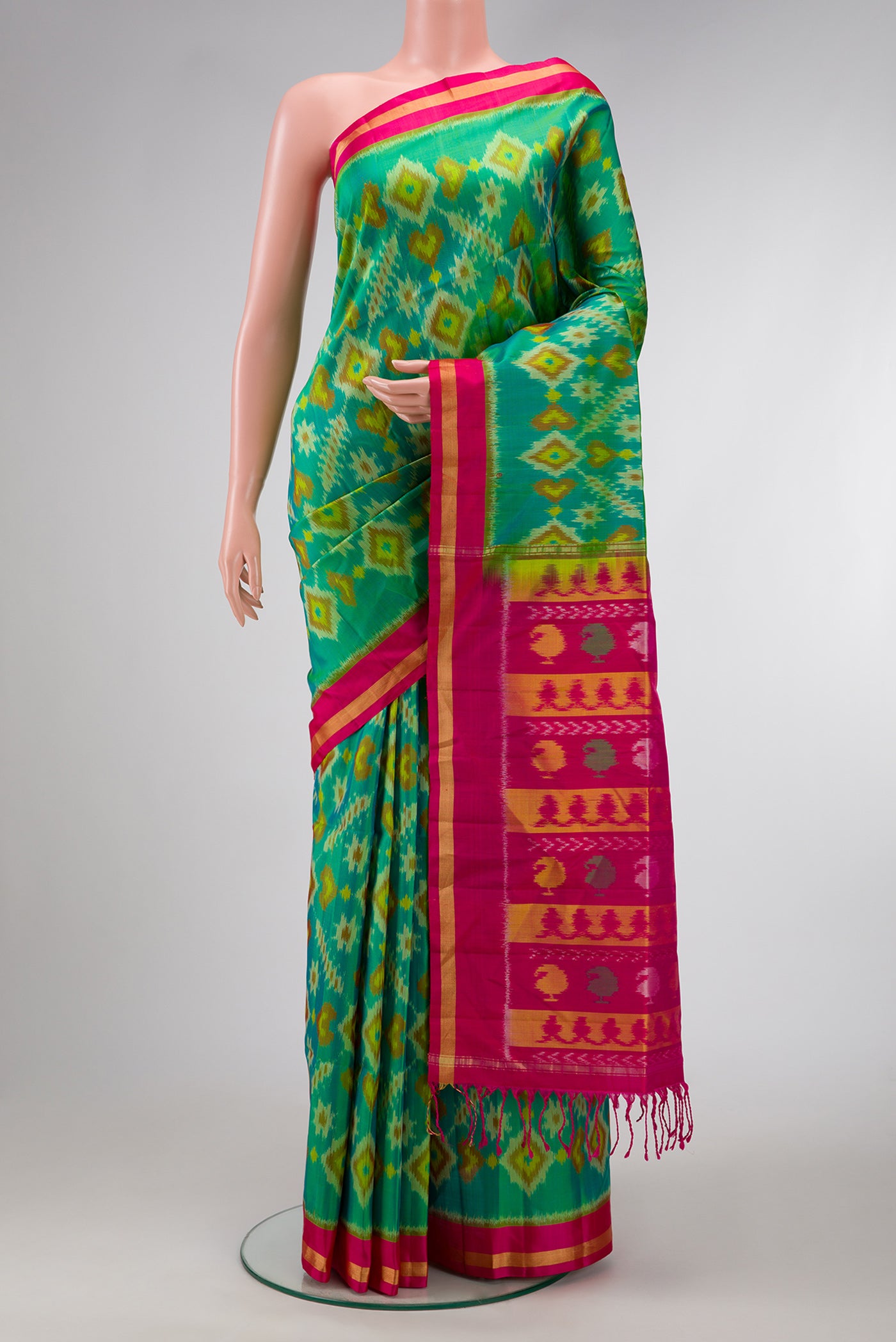 Green Dual Tone Soft Silk Saree with Ikat Print on the body and Zari Border.  displayed on a mannequin