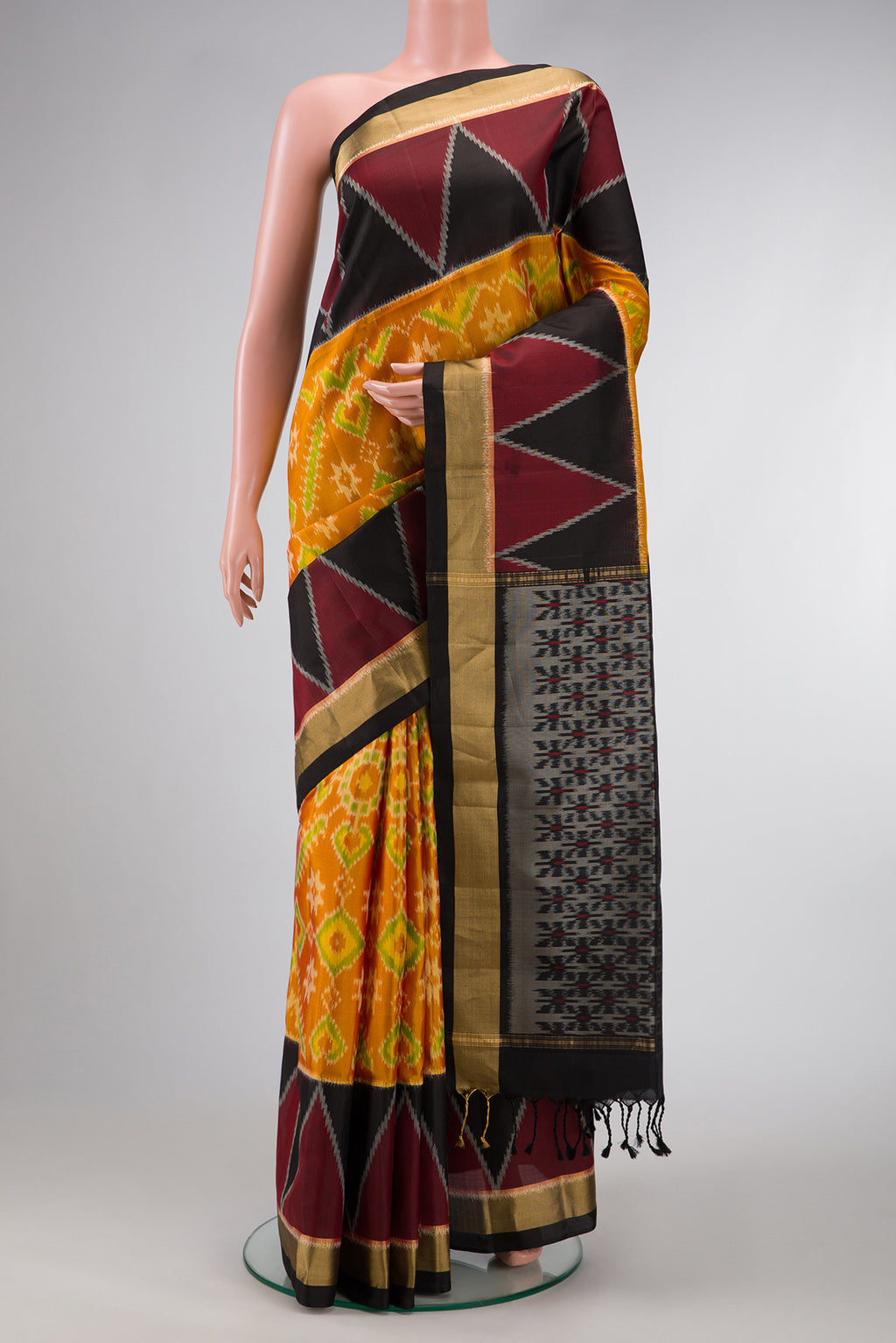 Mustard Dual Tone Soft Silk Saree with Ikat Print on the body and Ikat Border.  displayed on a mannequin