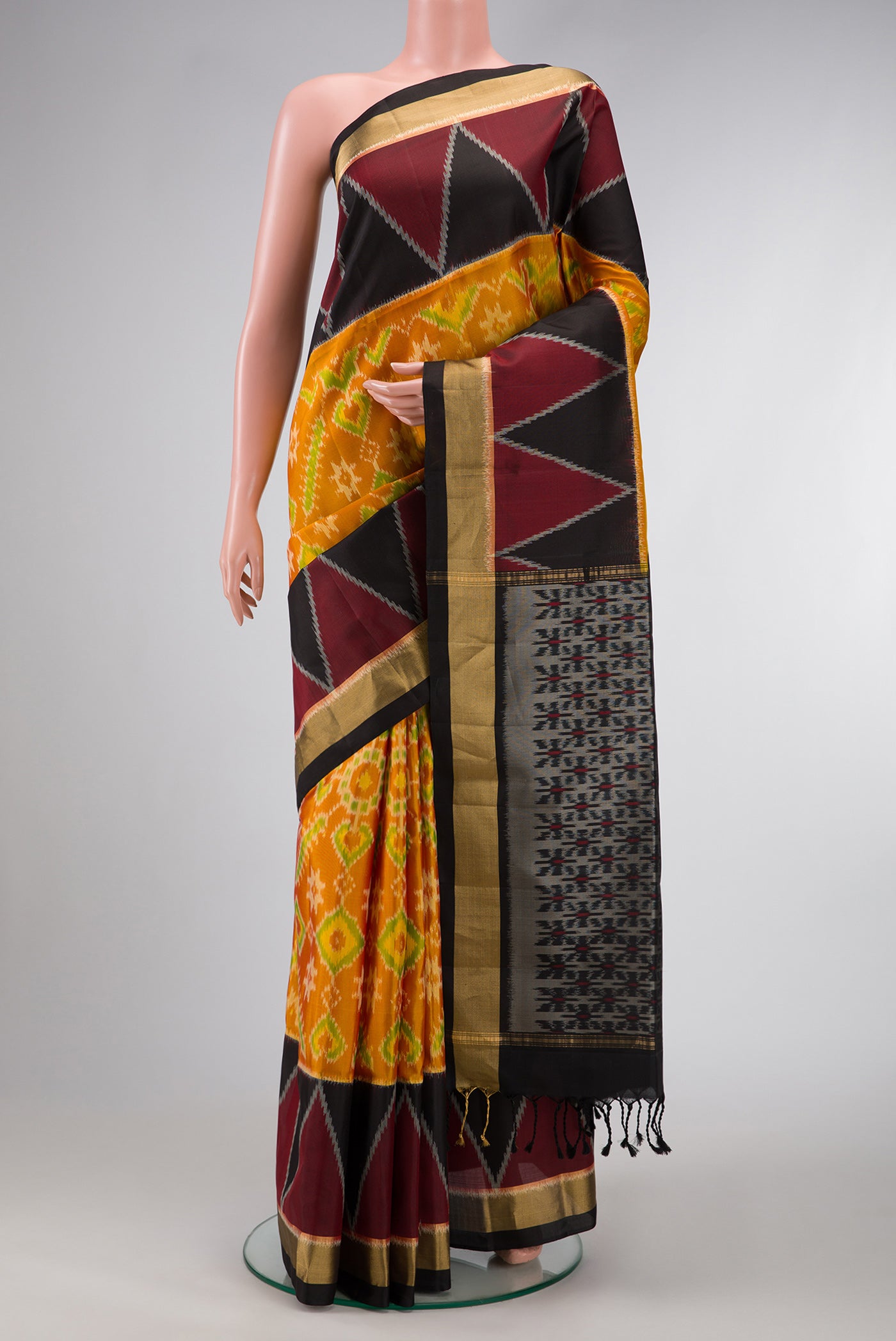 Mustard Dual Tone Soft Silk Saree with Ikat Print on the body and Ikat Border.  displayed on a mannequin