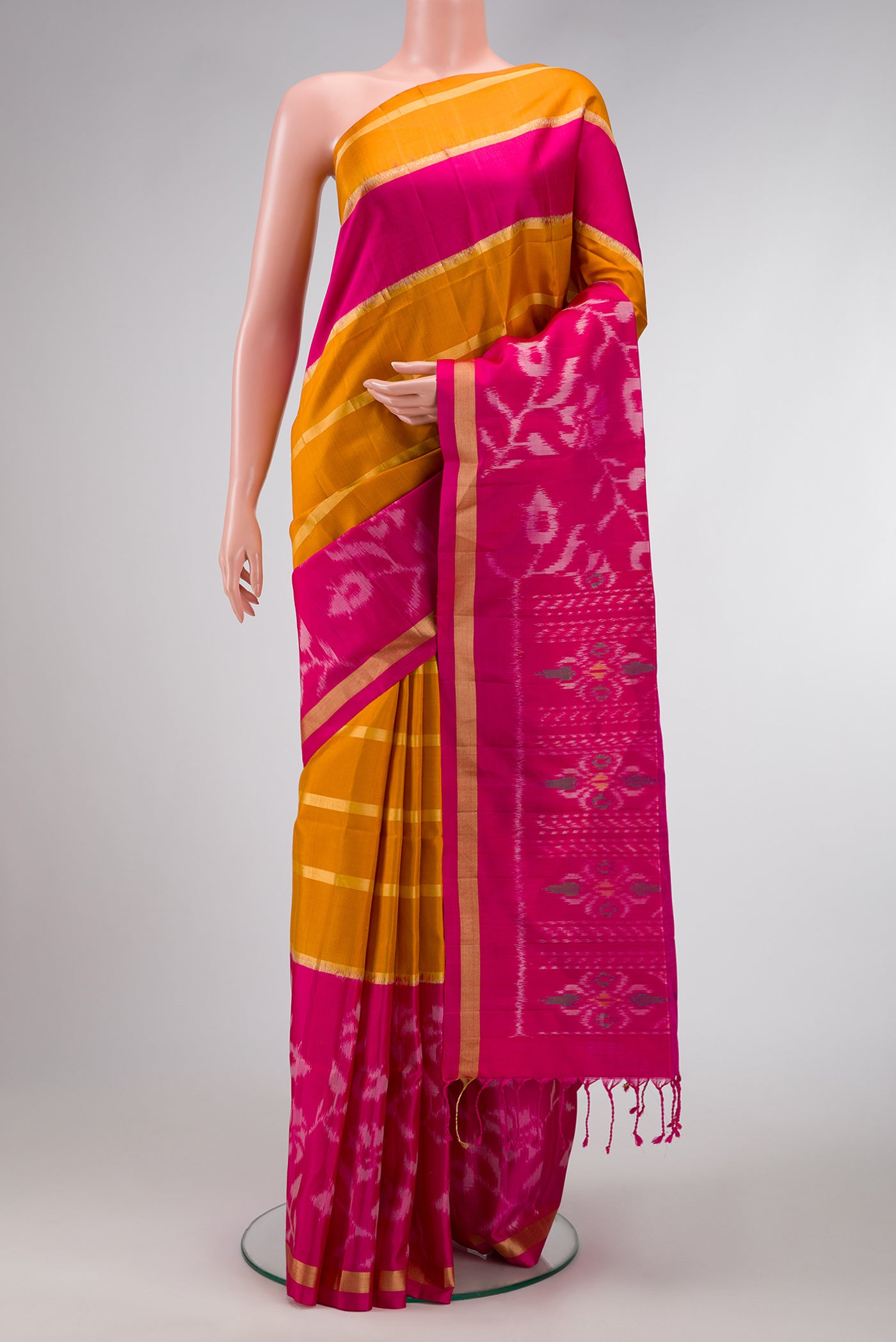 Mustard Dual Tone Soft Silk Saree with Stripes on the body and Ikat Border.  displayed on a mannequin