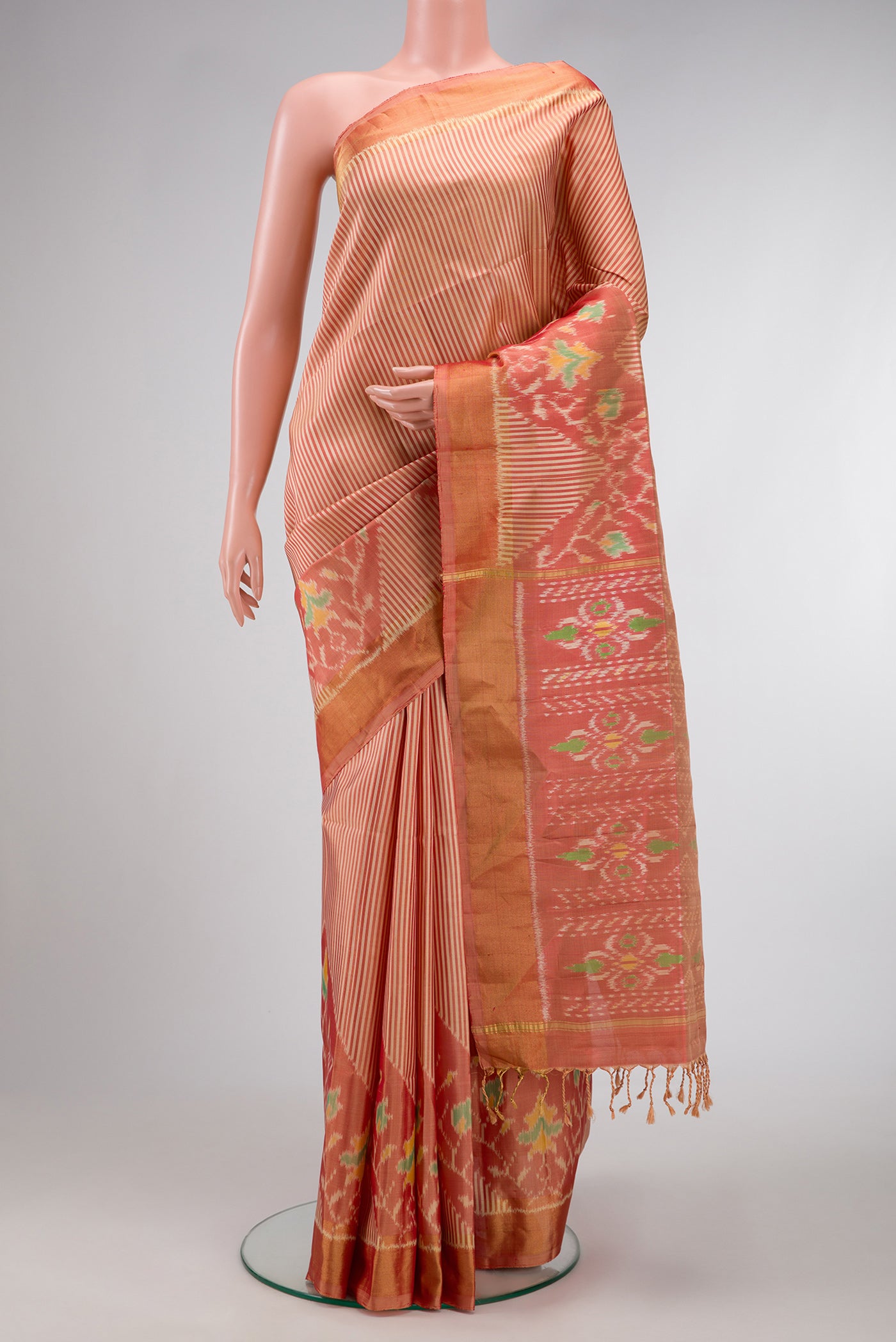 Golden Peach Dual Tone Soft Silk Saree with Stripes on the body and Ikat Border.  displayed on a mannequin