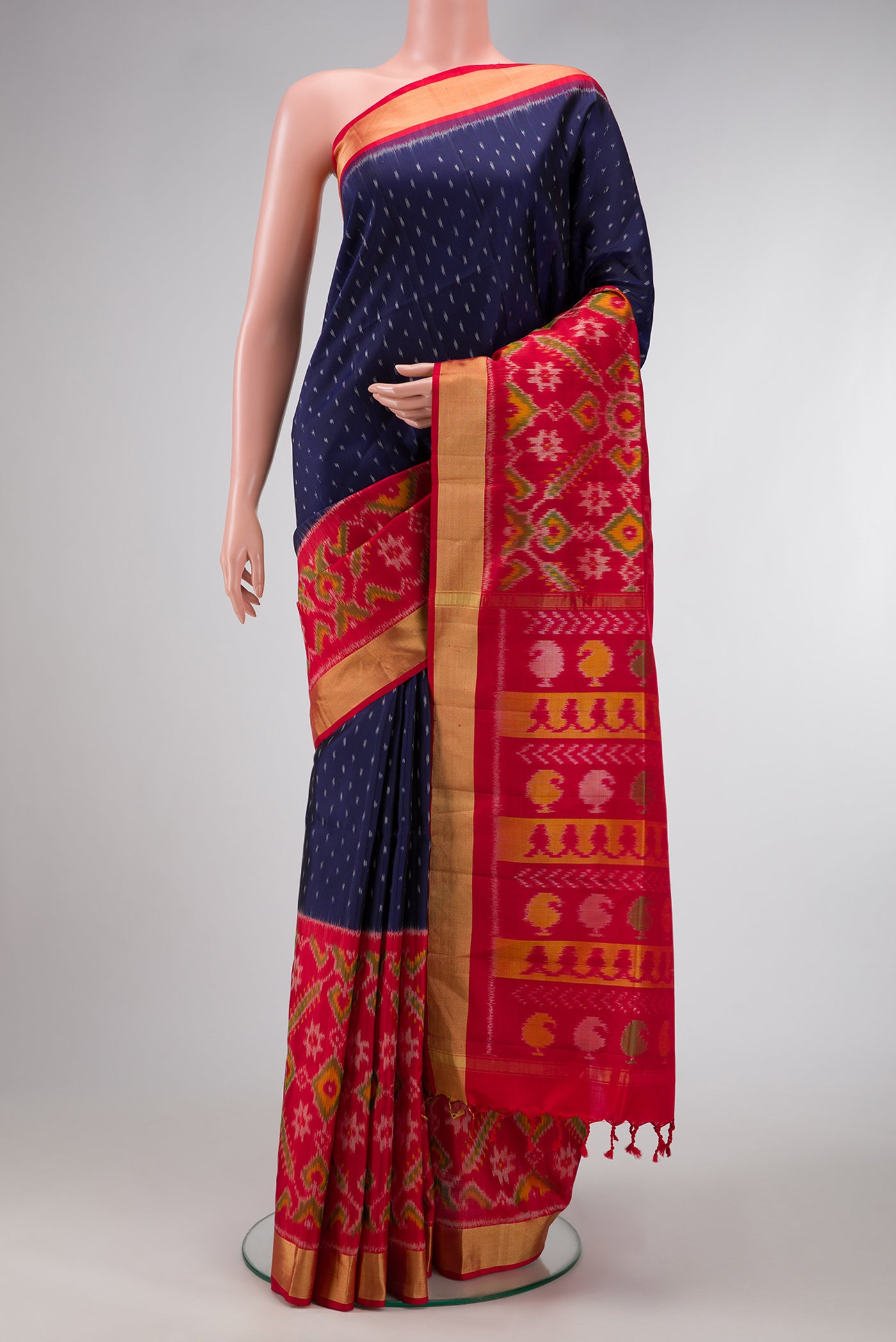 Navy Blue Dual Tone Soft Silk Saree with Ikat Print on the body and Ikat Border.  displayed on a mannequin