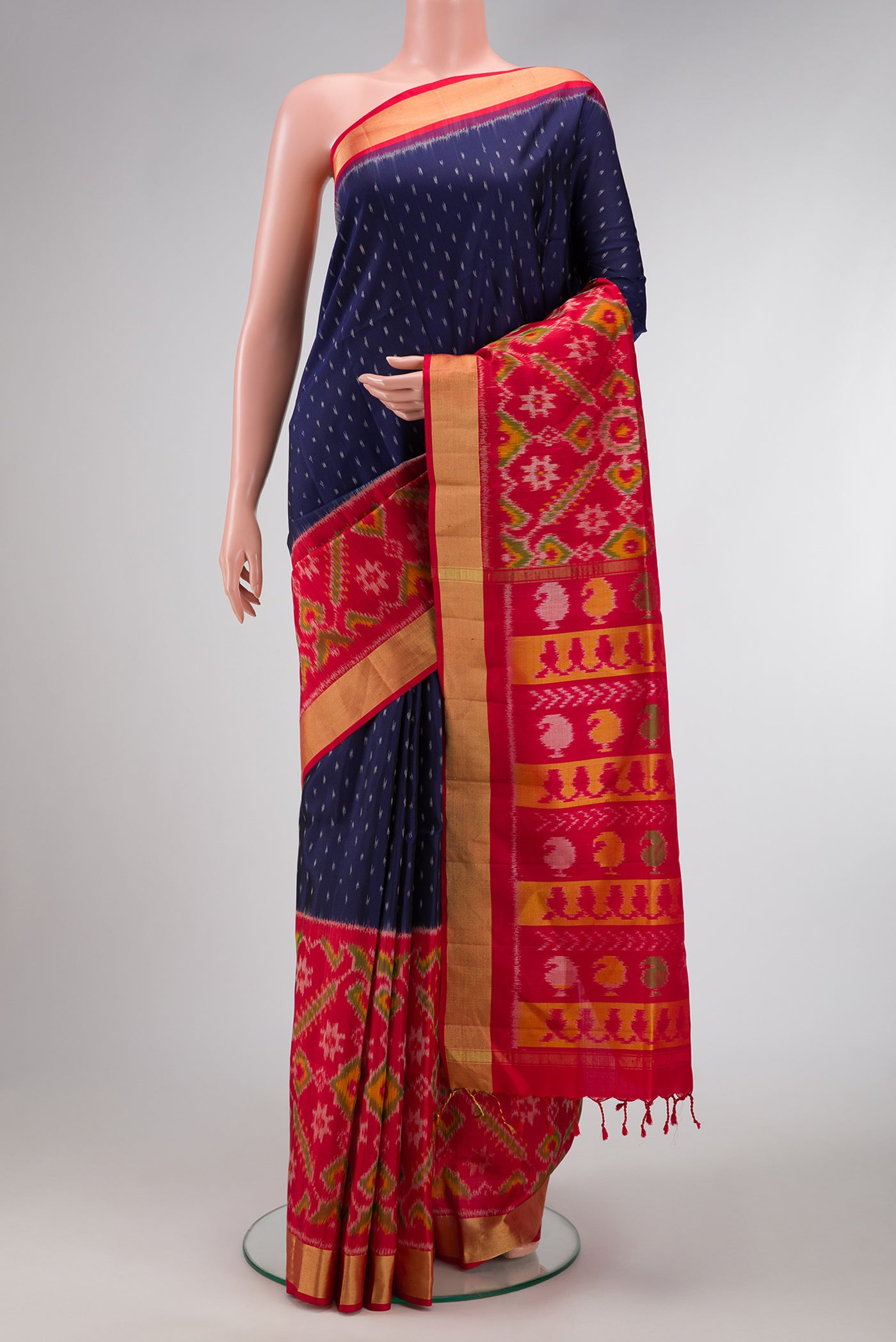 Navy Blue Dual Tone Soft Silk Saree with Ikat Print on the body and Ikat Border.  displayed on a mannequin