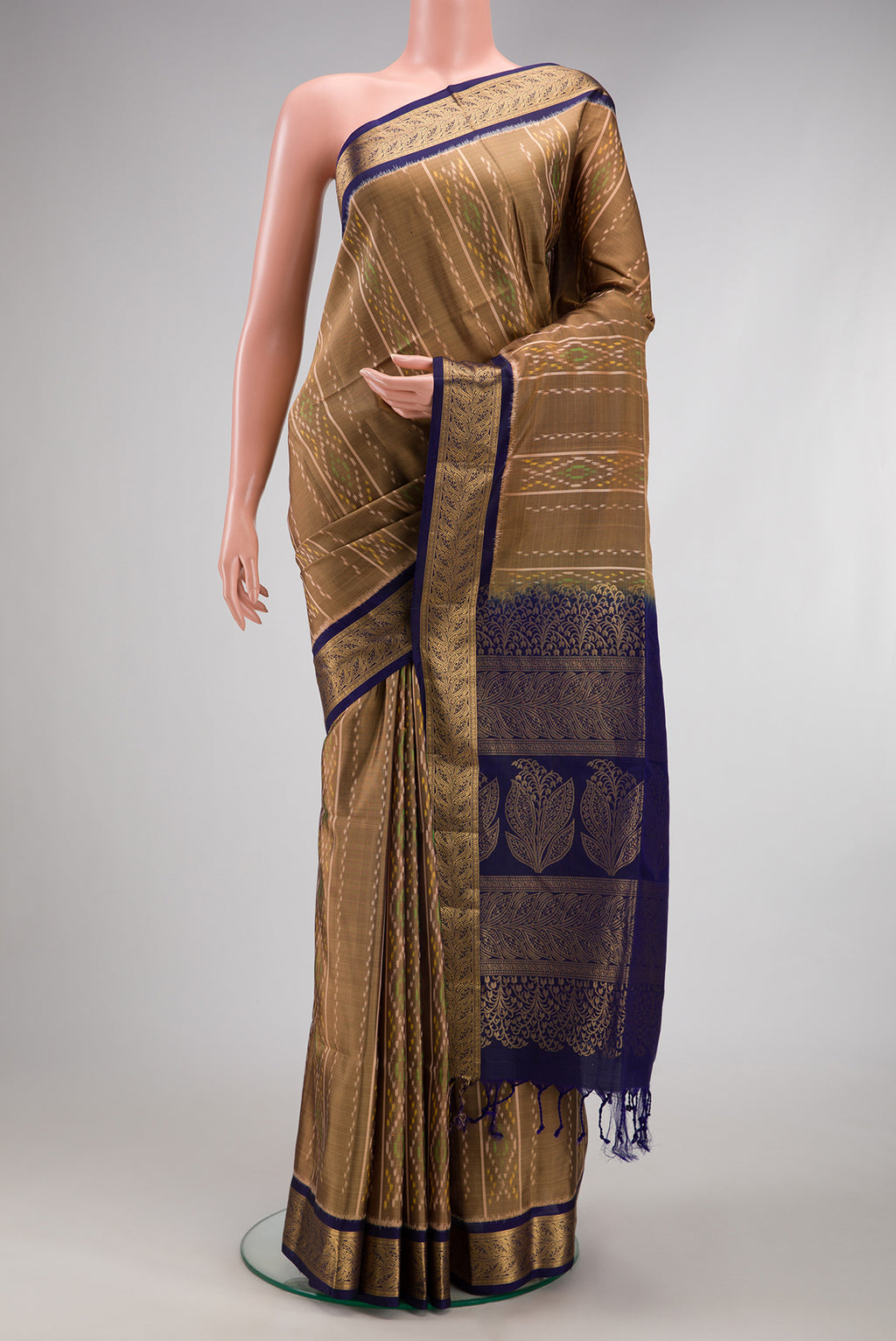 Dark Beige Soft Silk Saree with Ikat design on the body and Zari Border.  displayed on a mannequin