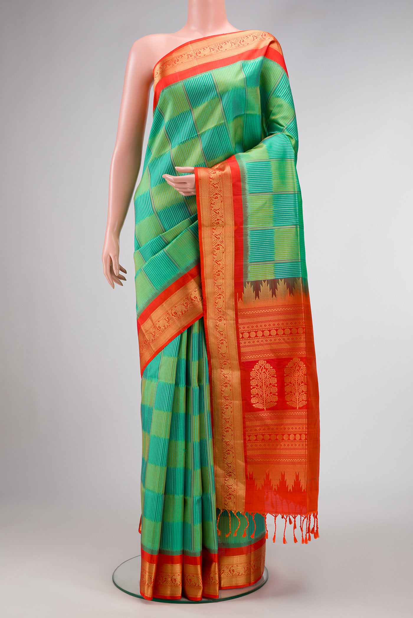 Green Dual Tone Soft Silk Saree with Ikat Print on the body and Zari Border.  displayed on a mannequin
