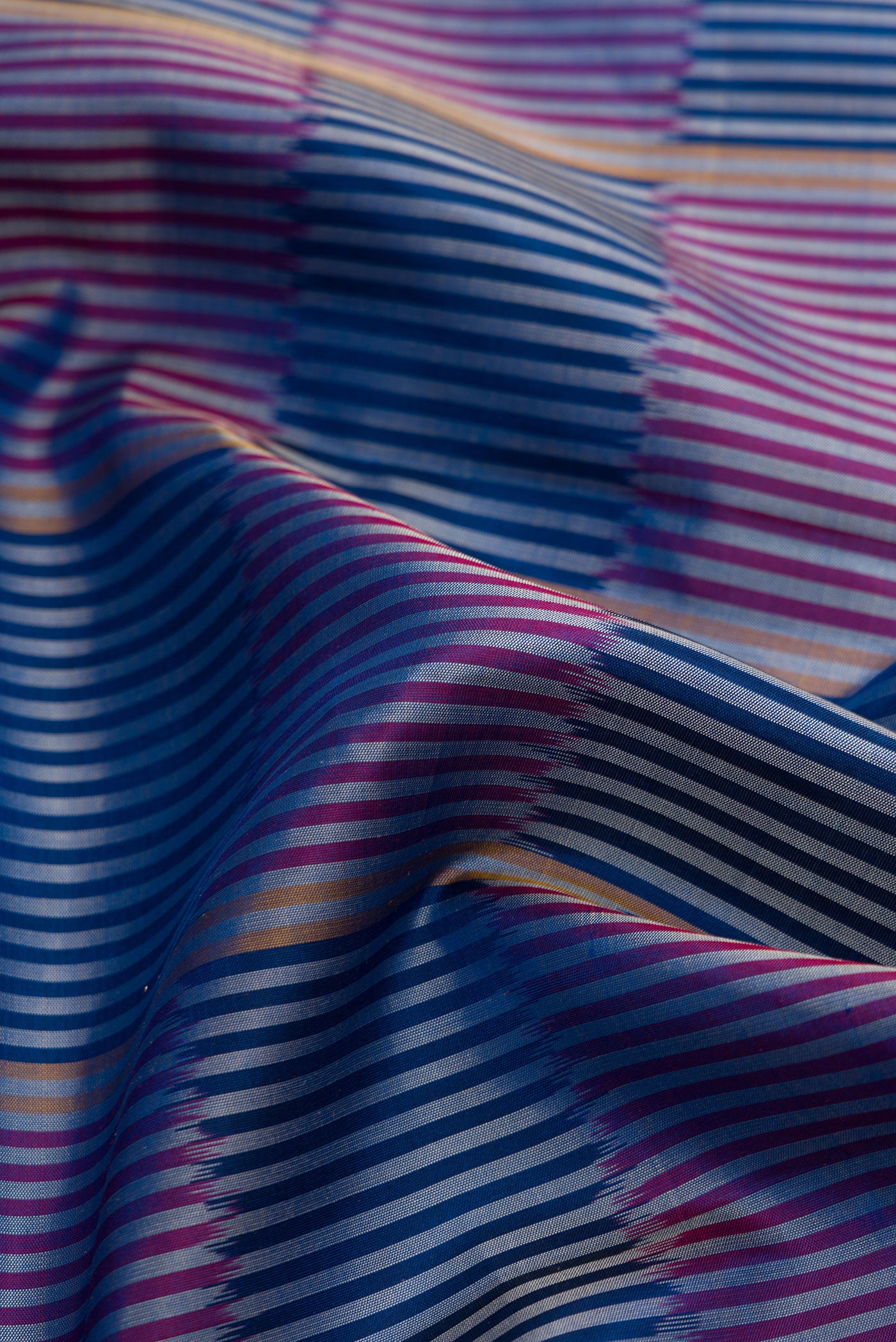 Close up of Royal Blue Dual Tone Soft Silk Saree with Checked design on the body and Zari Border.  displaying folds