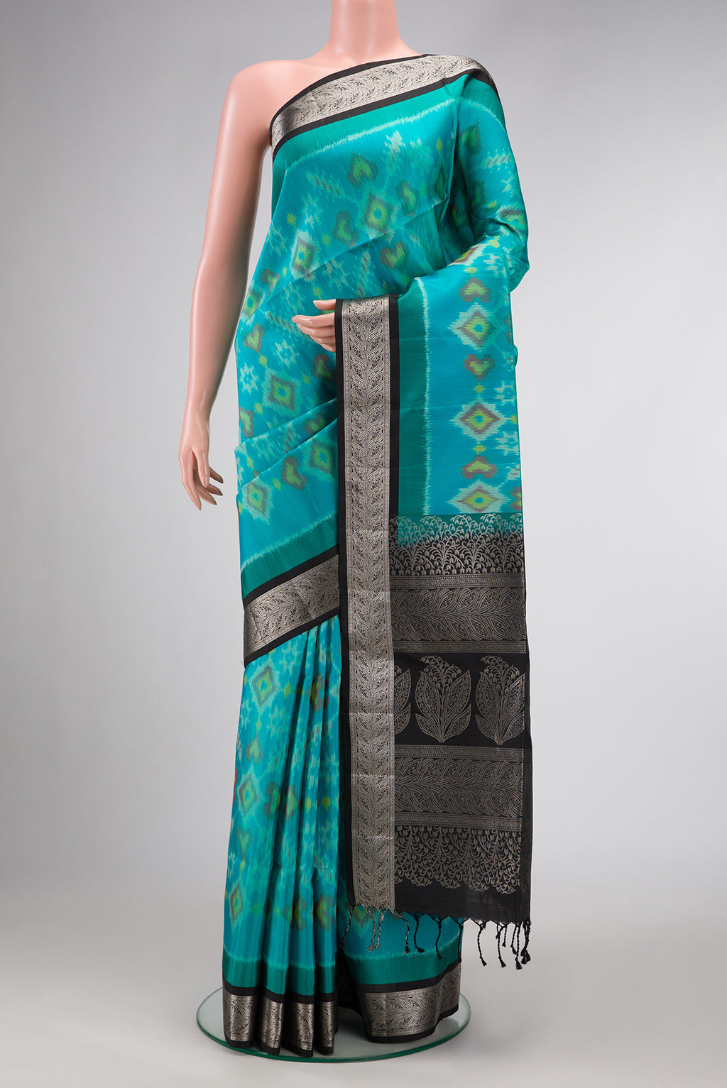 Sky Blue Dual Tone Soft Silk Saree with Ikat Print on the body and Zari Border.  displayed on a mannequin