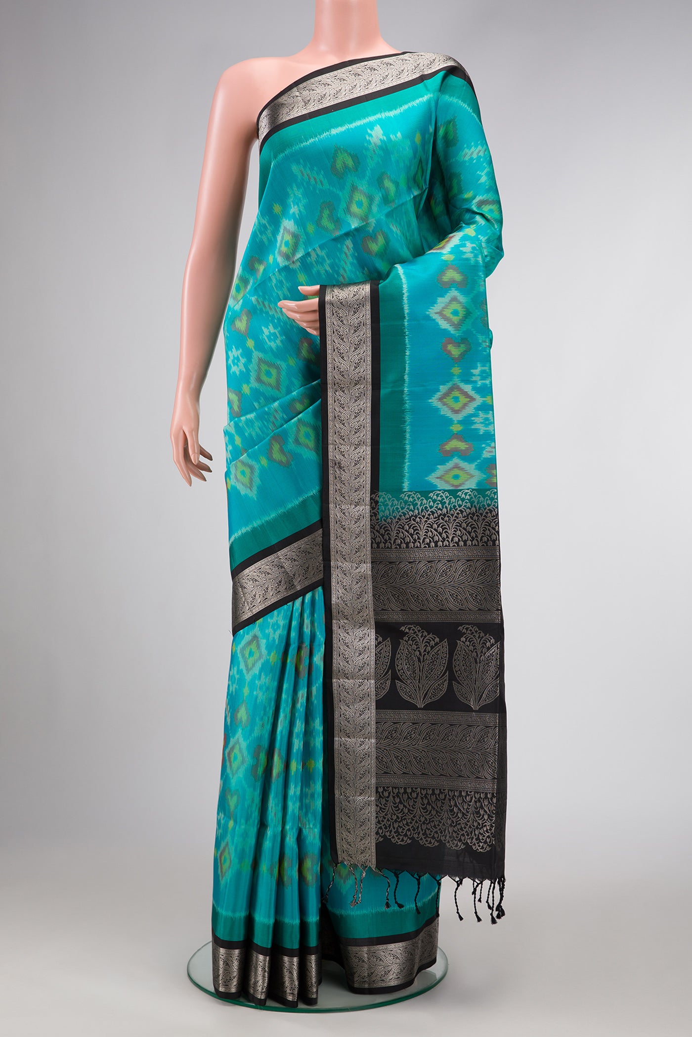 Sky Blue Dual Tone Soft Silk Saree with Ikat Print on the body and Zari Border.  displayed on a mannequin