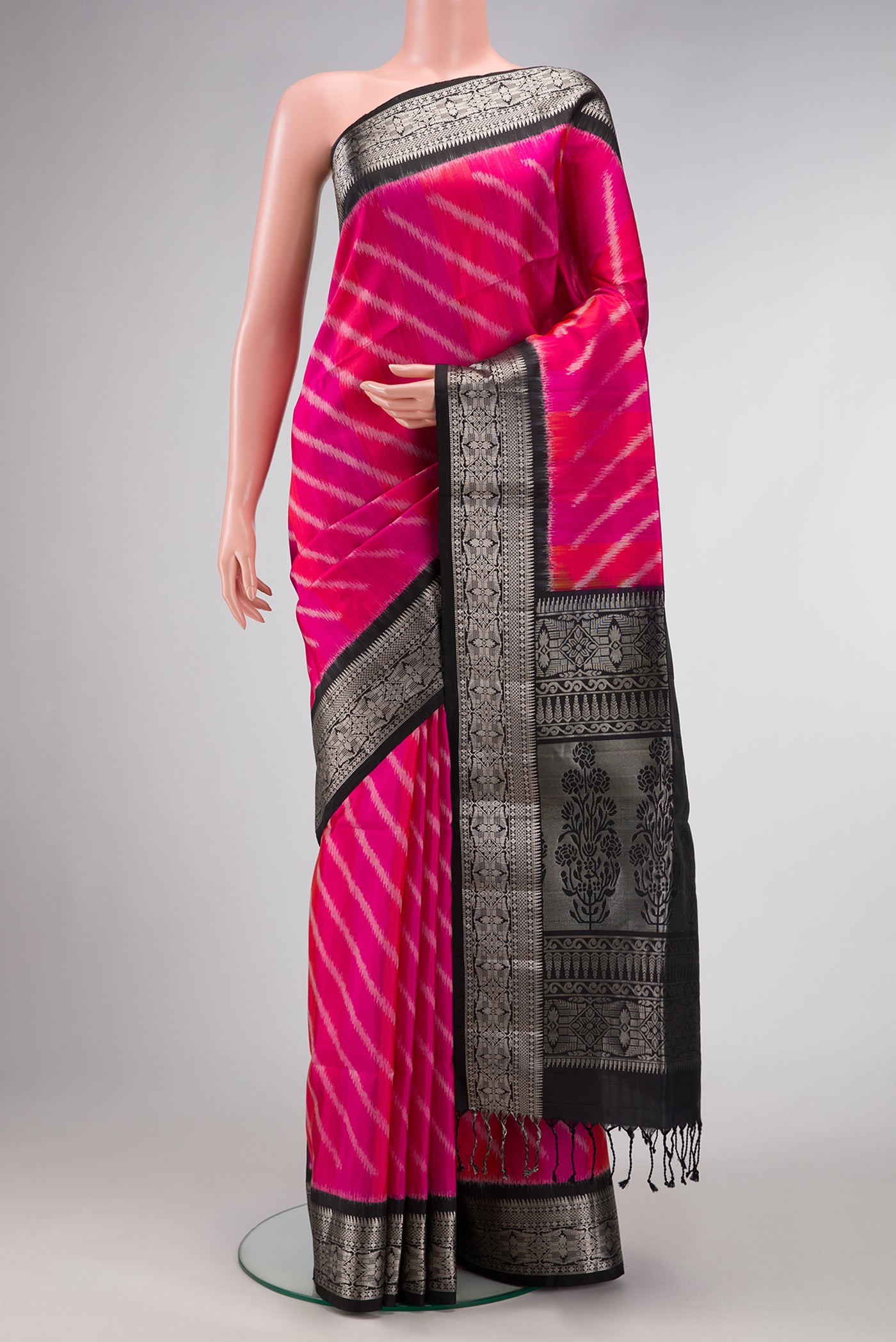 Pink Dual Tone Soft Silk Saree with Ikat Print on the body and Zari Border.  displayed on a mannequin