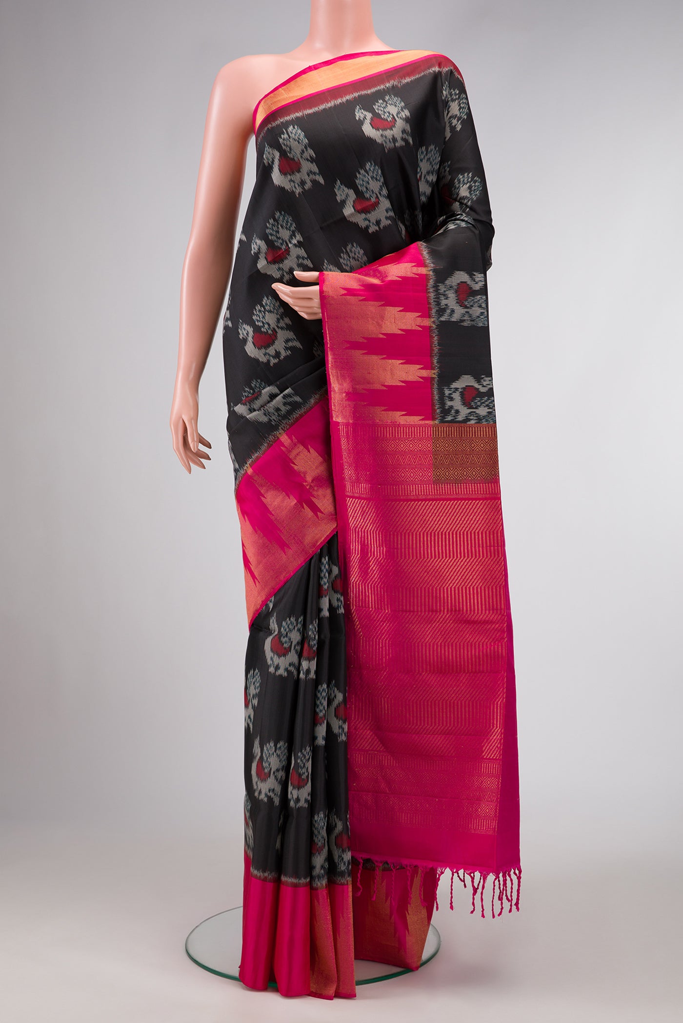Black Dual Tone Soft Silk Saree with Ikat Print on the body and Zari Border.  displayed on a mannequin