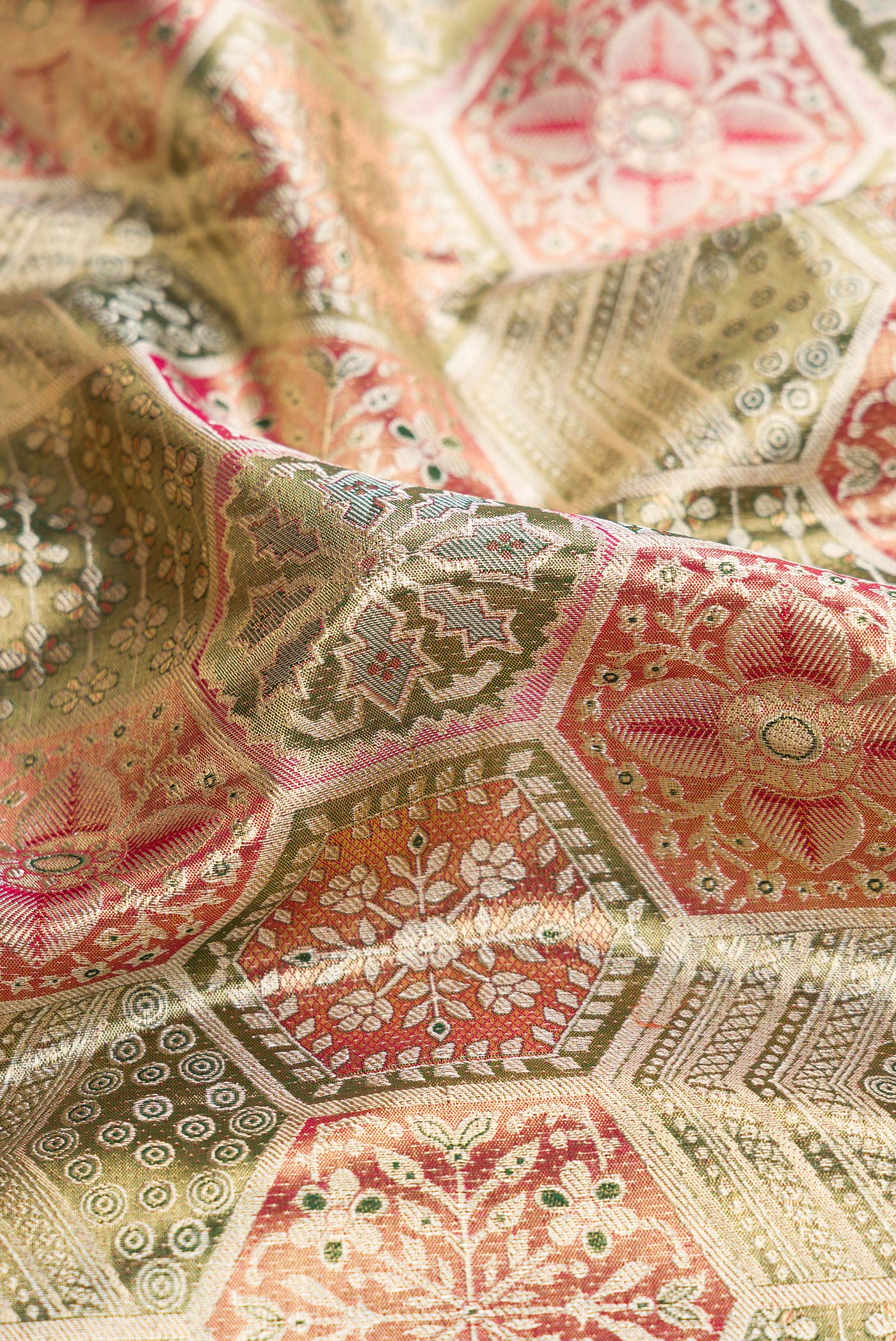 Close up of Gold Dual Tone Kanjivaram Tissue Silk Saree with Zari Brocade on the body and Zari Border.  displaying folds