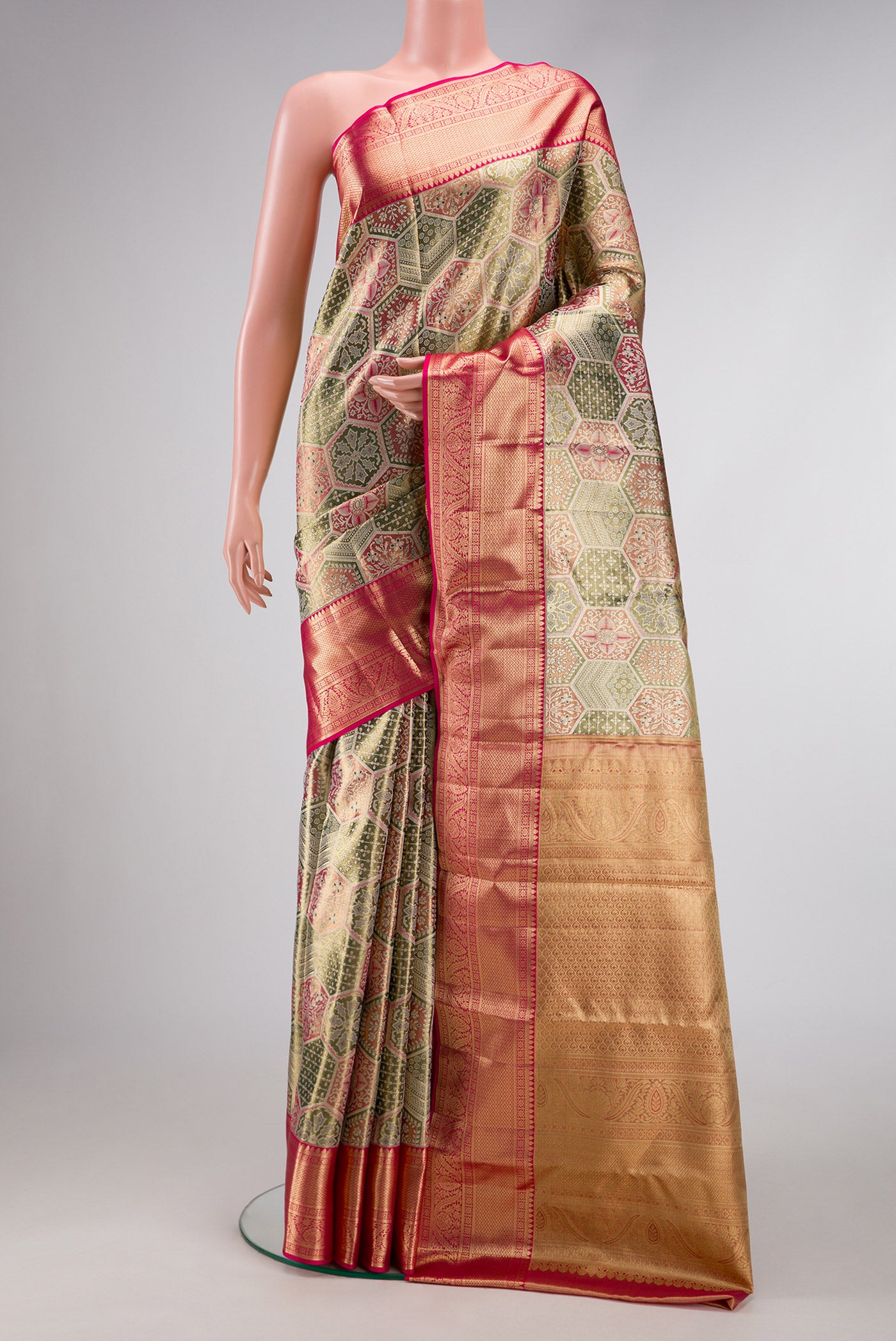 Gold Dual Tone Kanjivaram Tissue Silk Saree with Zari Brocade on the body and Zari Border.  displayed on a mannequin