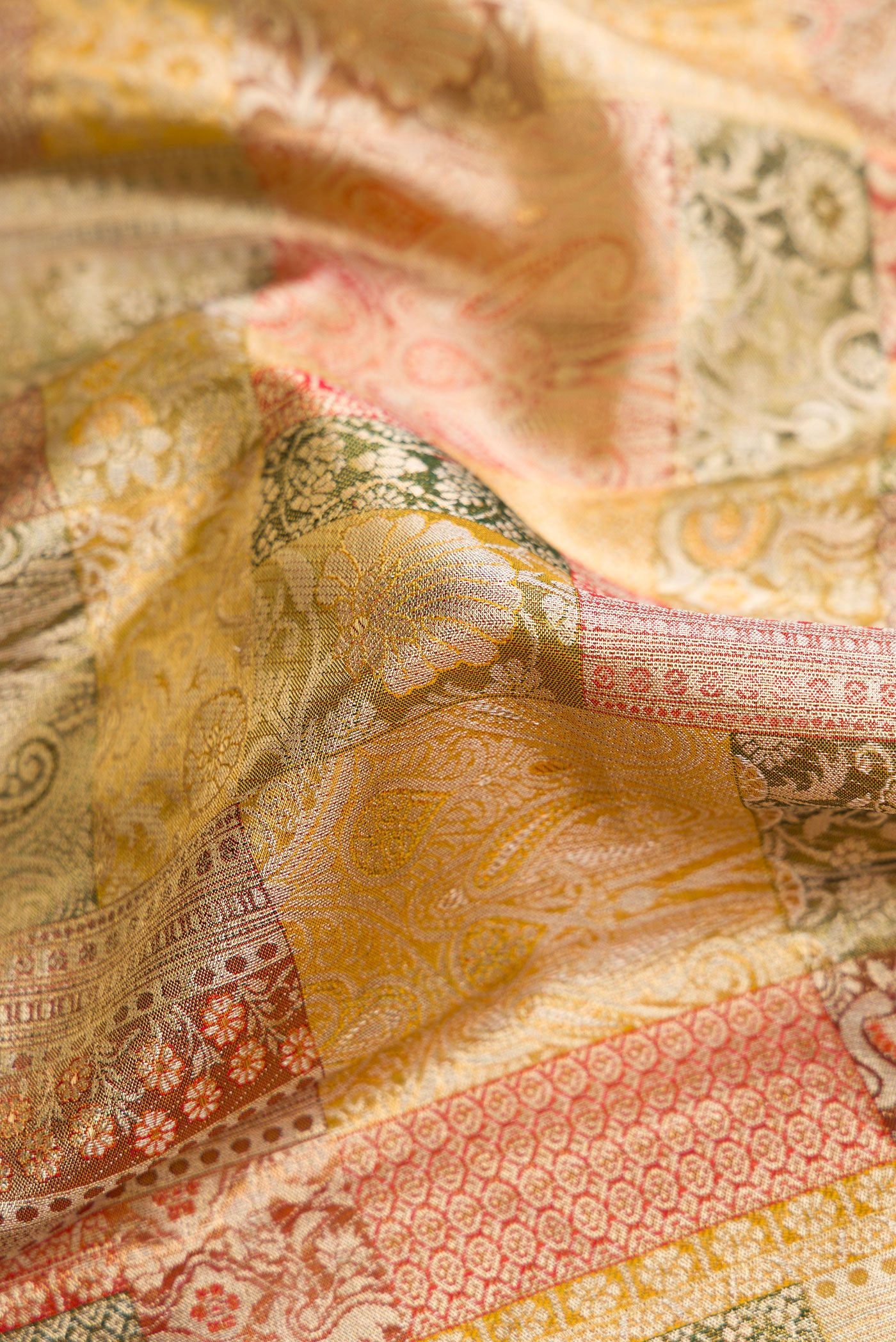 Close up of Gold Dual Tone Kanjivaram Tissue Silk Saree with Zari Brocade on the body and Zari Border.  displaying folds