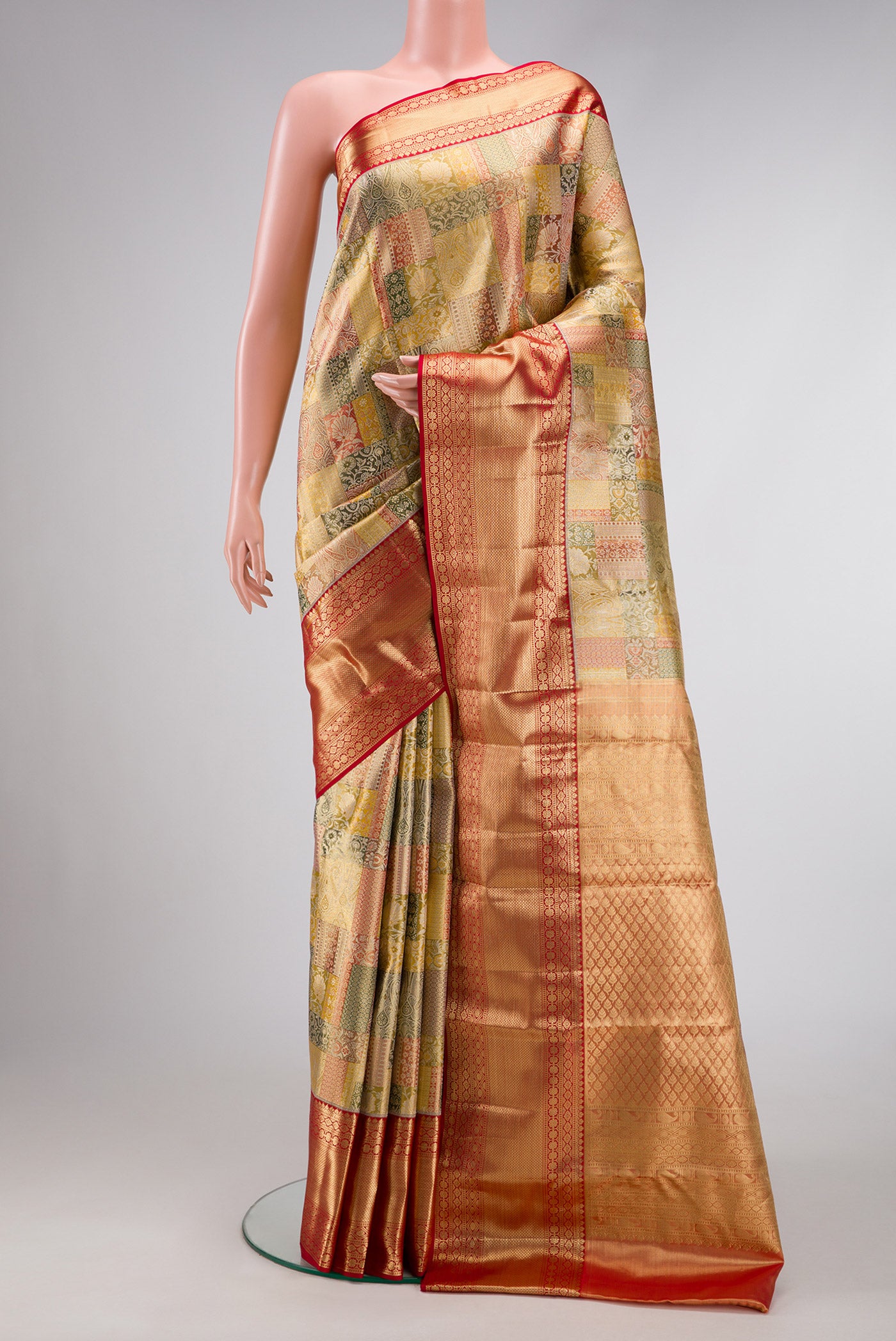 Gold Dual Tone Kanjivaram Tissue Silk Saree with Zari Brocade on the body and Zari Border.  displayed on a mannequin