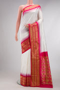 White Dual Tone Double Ikat Saree with Ikat Print on the body and Zari Border.  displayed on a mannequin