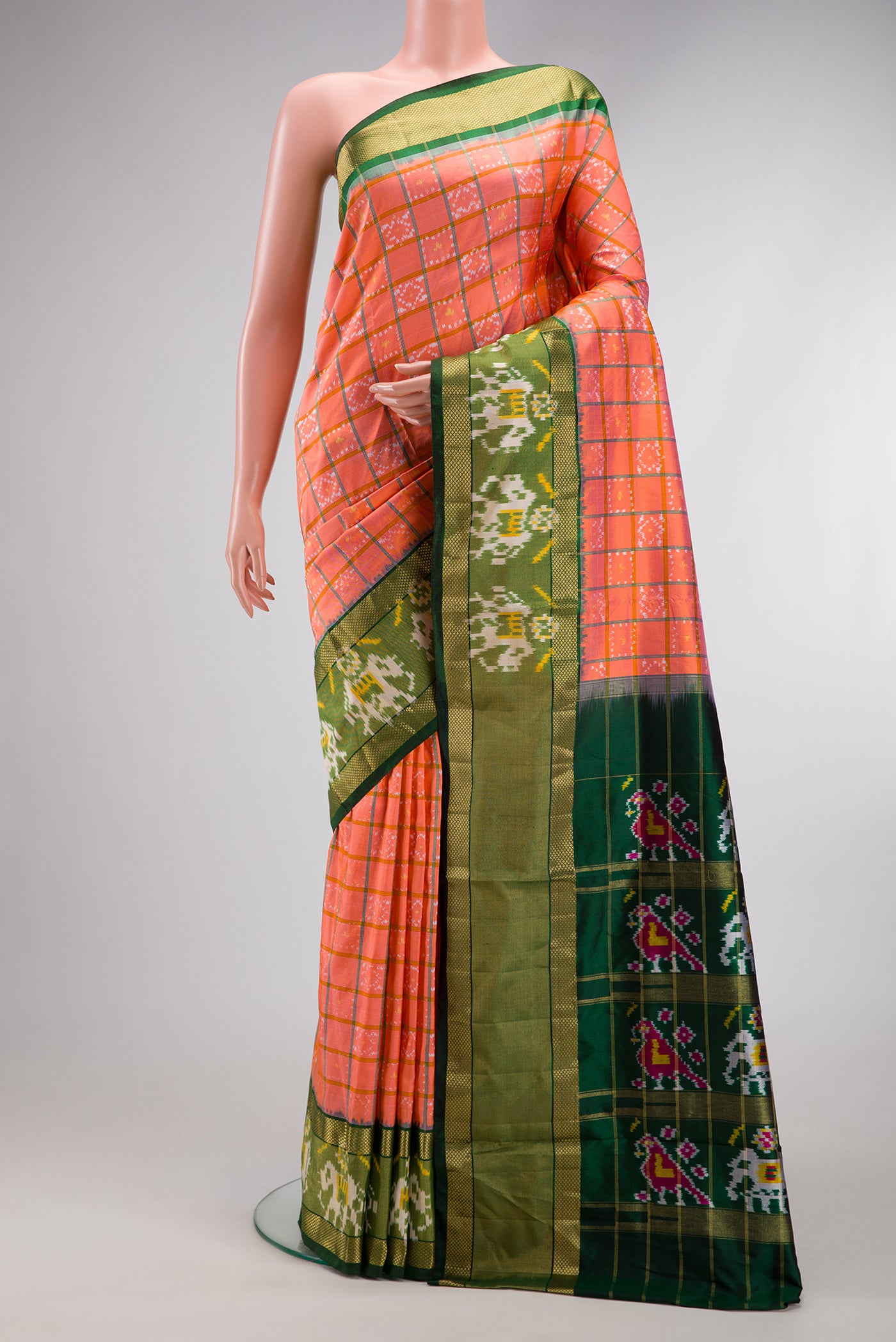 Peach Dual Tone Double Ikat Saree with Ikat Print on the body and Ikat Border.  displayed on a mannequin