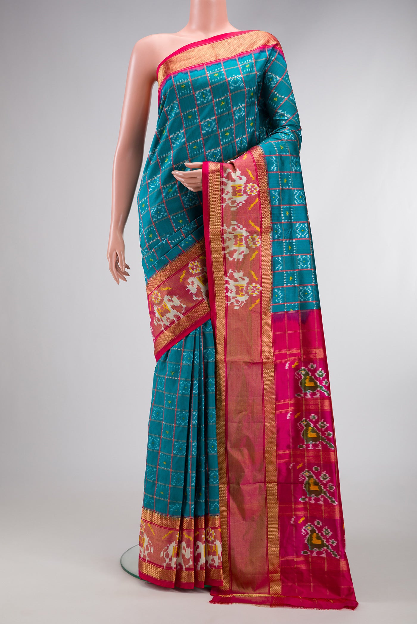 Peacock Blue Dual Tone Double Ikat Saree with Ikat Print on the body and Ikat Border.  displayed on a mannequin