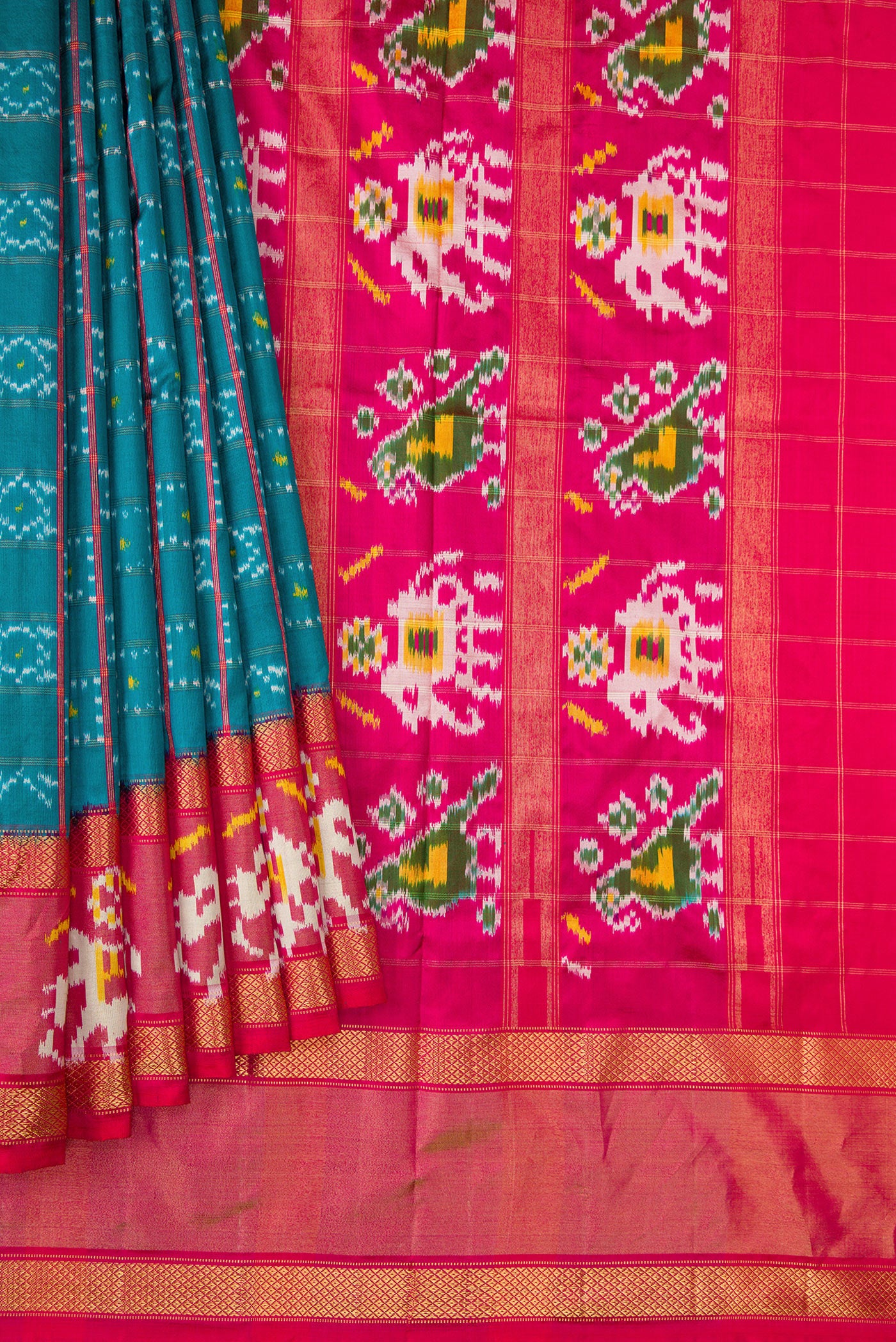 Pleats and pallu of Peacock Blue Dual Tone Double Ikat Saree with Ikat Print on the body and Ikat Border. 