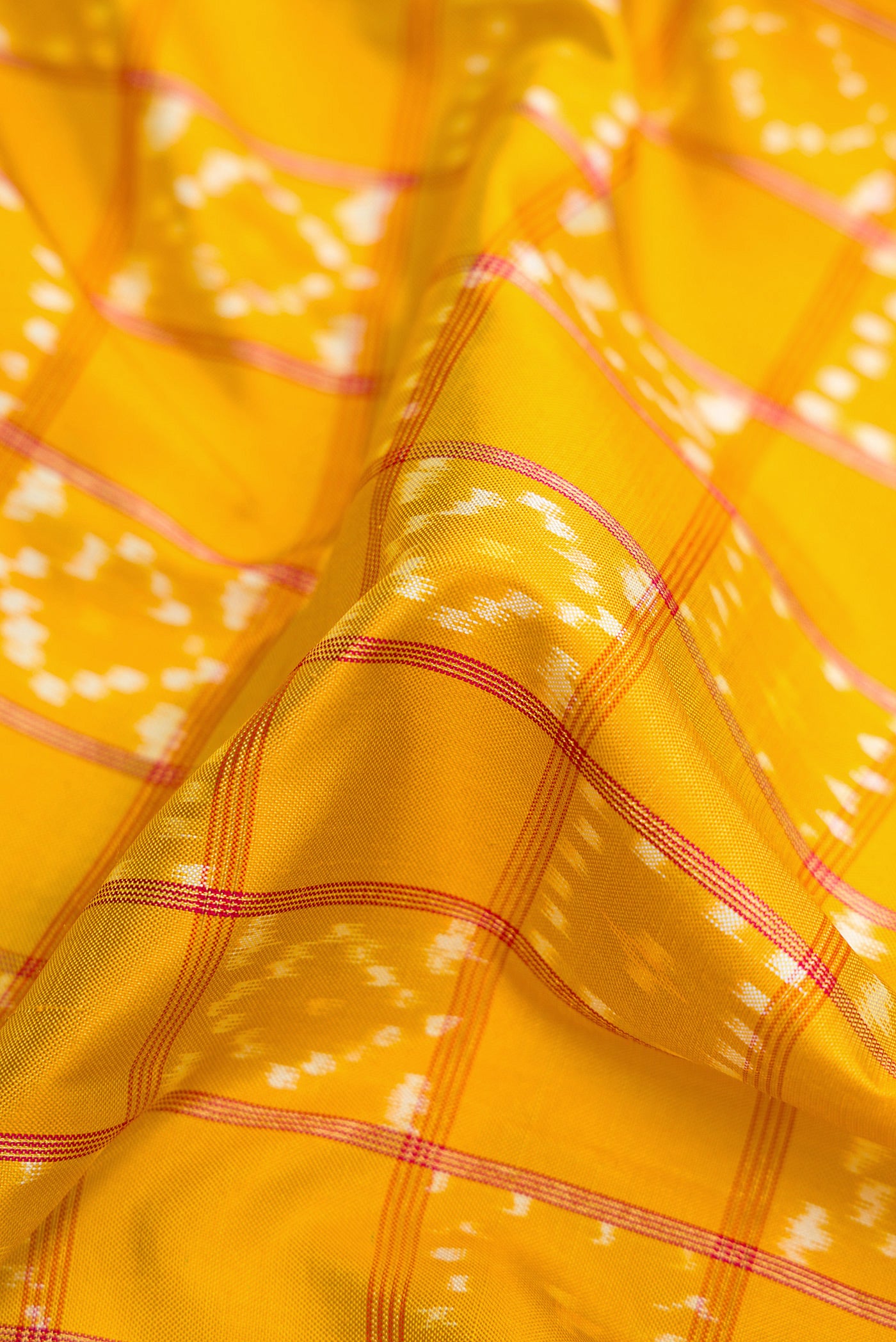 Close up of Pink Dual Tone Double Ikat Saree with Ikat Print on the body and Ikat Border.  displaying folds