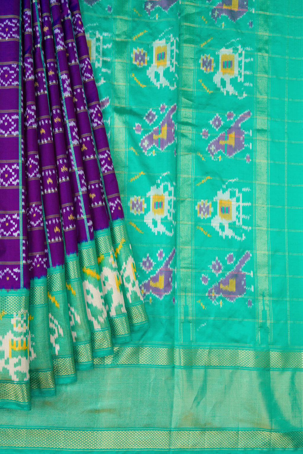 Pleats and pallu of Purple Dual Tone Double Ikat Saree with Ikat Print on the body and Ikat Border. 