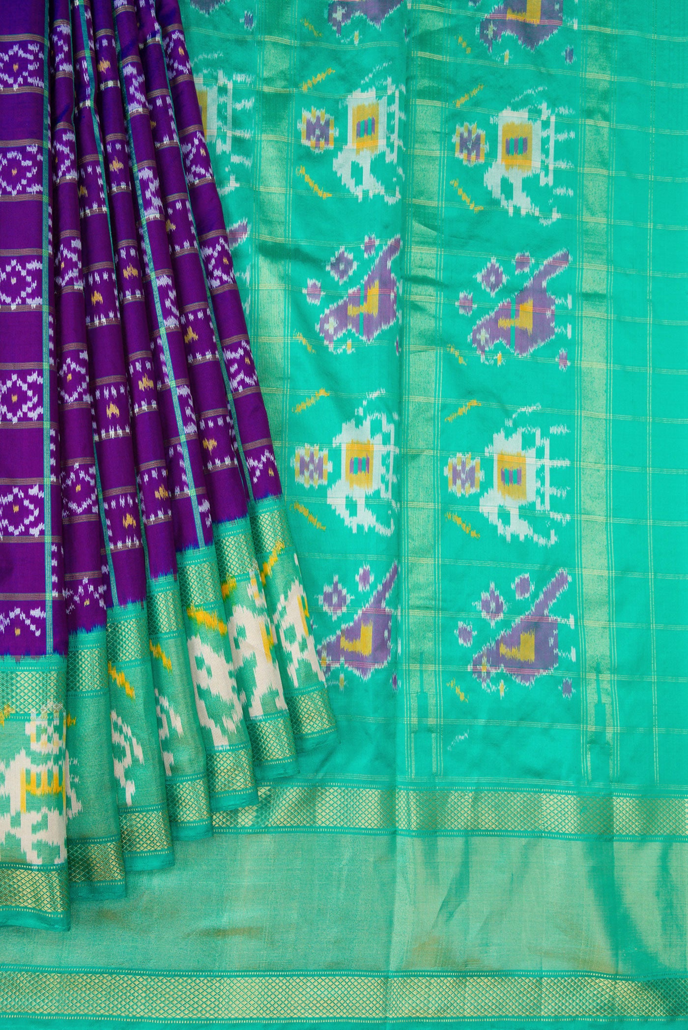 Pleats and pallu of Purple Dual Tone Double Ikat Saree with Ikat Print on the body and Ikat Border. 