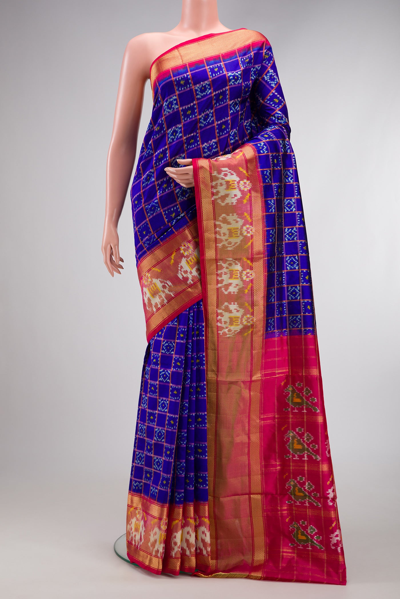 Navy Blue Dual Tone Double Ikat Saree with Ikat Print on the body and Ikat Border.  displayed on a mannequin