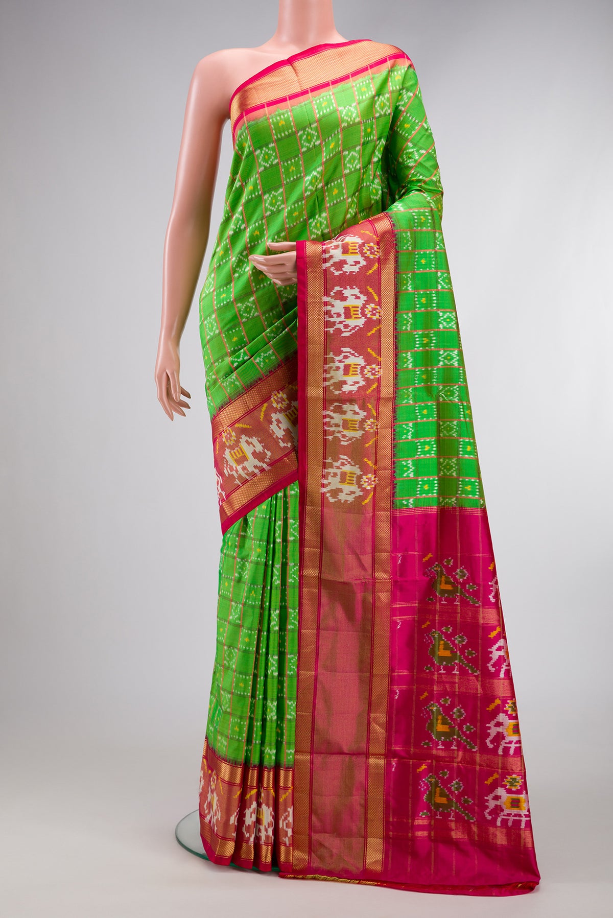 Parrot Green Dual Tone Double Ikat Saree with Ikat Print on the body and Ikat Border.  displayed on a mannequin