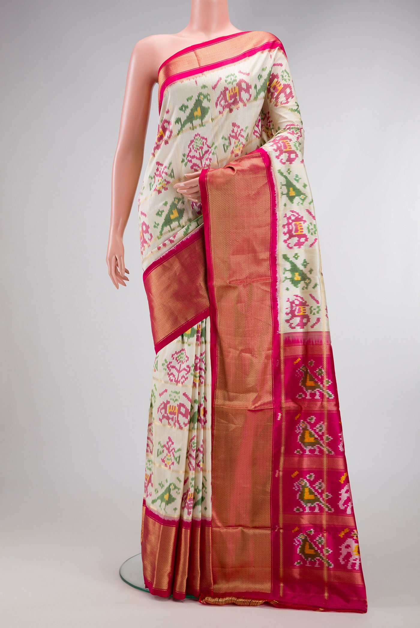 Off White Dual Tone Double Ikat Saree with Ikat Print on the body and Zari Border.  displayed on a mannequin