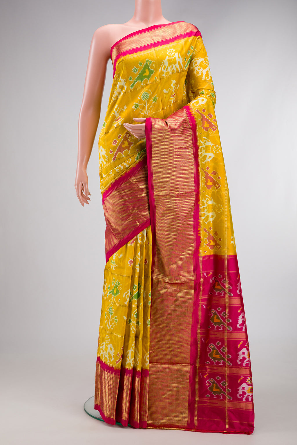 Mustard Dual Tone Double Ikat Saree with Ikat Print on the body and Zari Border.  displayed on a mannequin