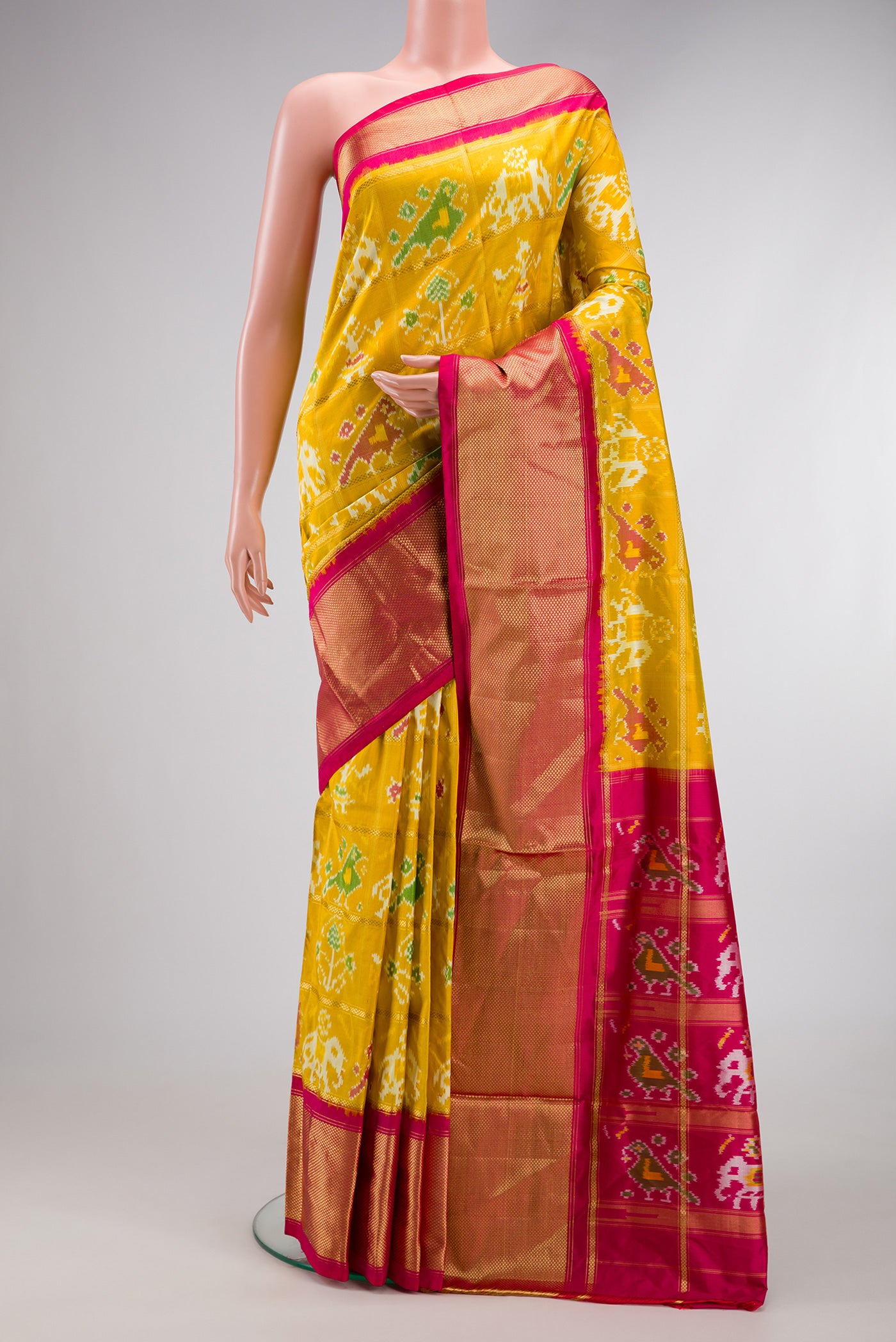 Mustard Dual Tone Double Ikat Saree with Ikat Print on the body and Zari Border.  displayed on a mannequin