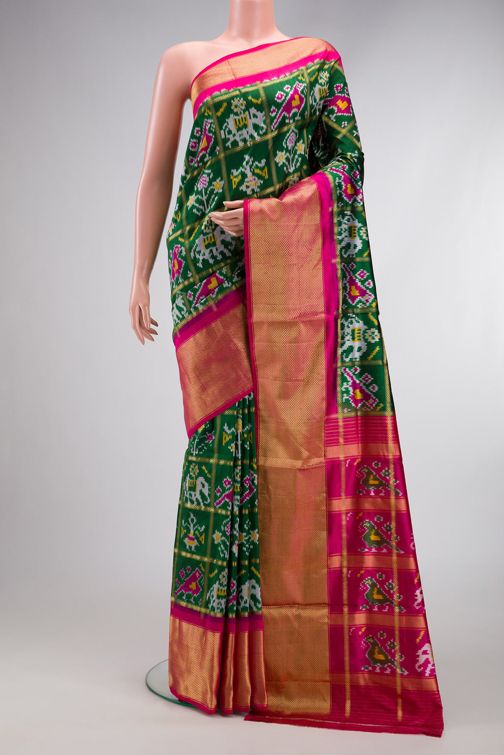 Bottle Green Dual Tone Double Ikat Saree with Ikat Print on the body and Zari Border.  displayed on a mannequin